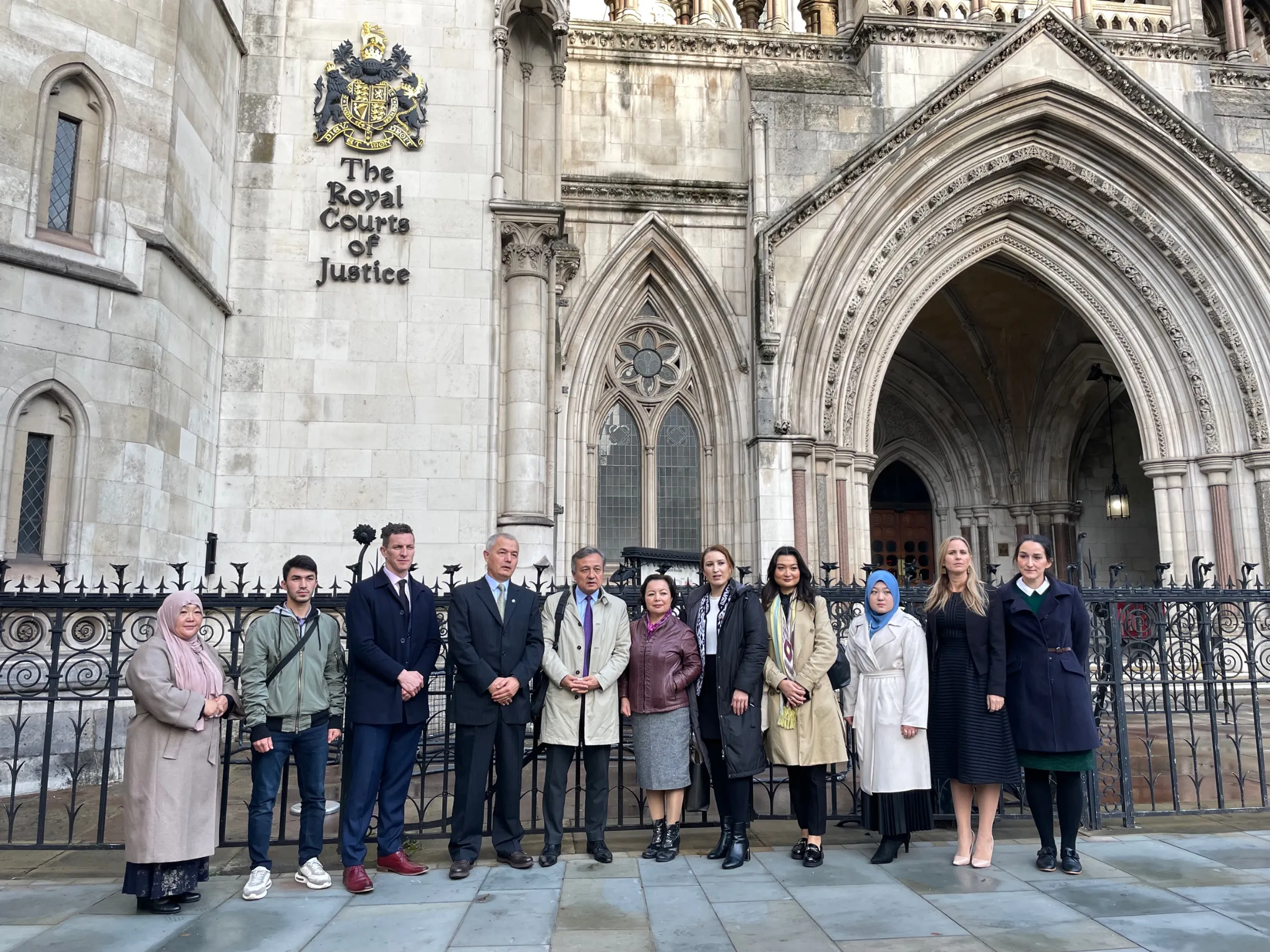 Uyghur activists and lawyers pose for a photo outside the High Court, Royal Courts of Justice on 25 October 2022, in London, Britain. THOMSON REUTERS FOUNDATION / Lin Taylor