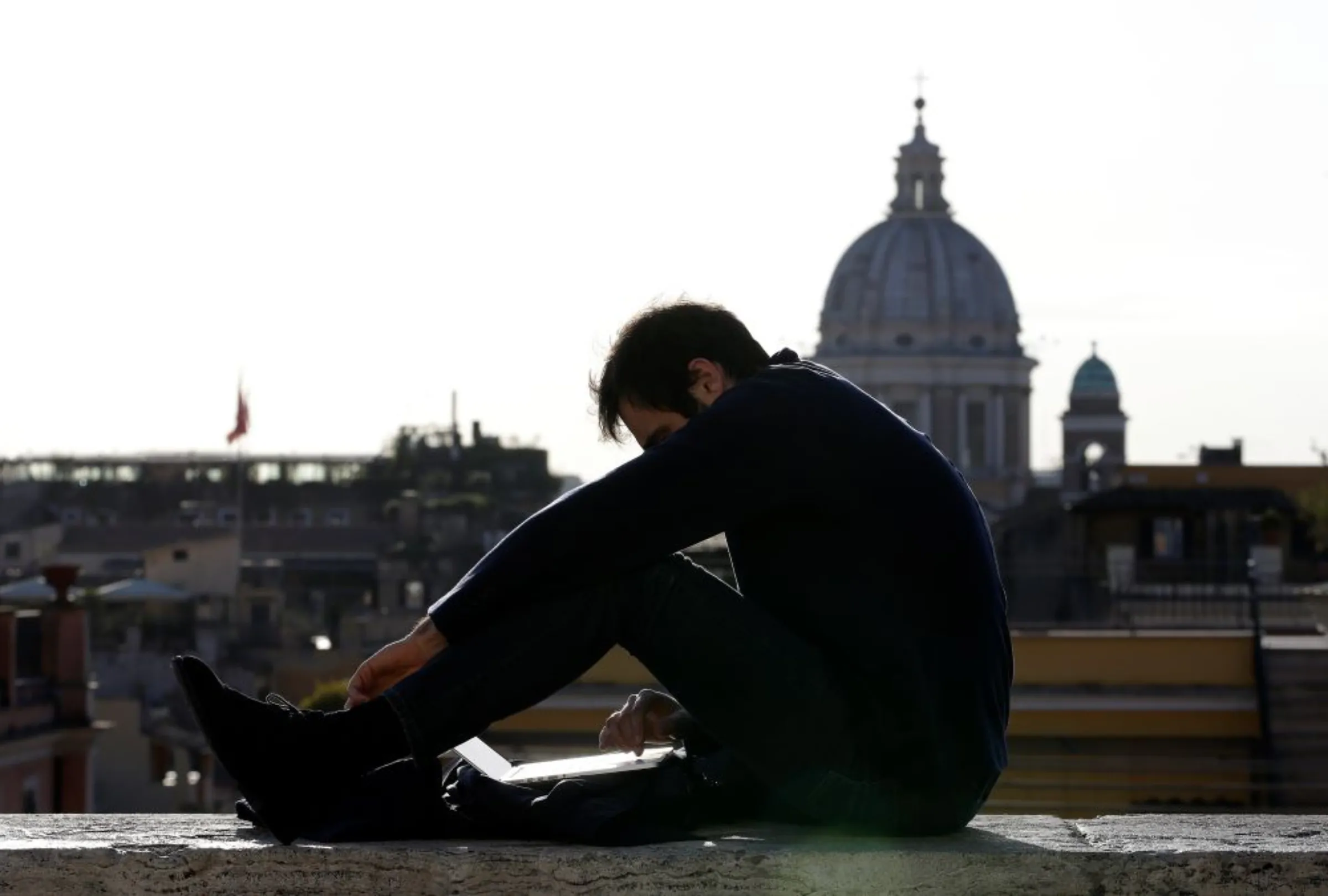 A man uses a laptop in Rome, Italy March 1, 2016