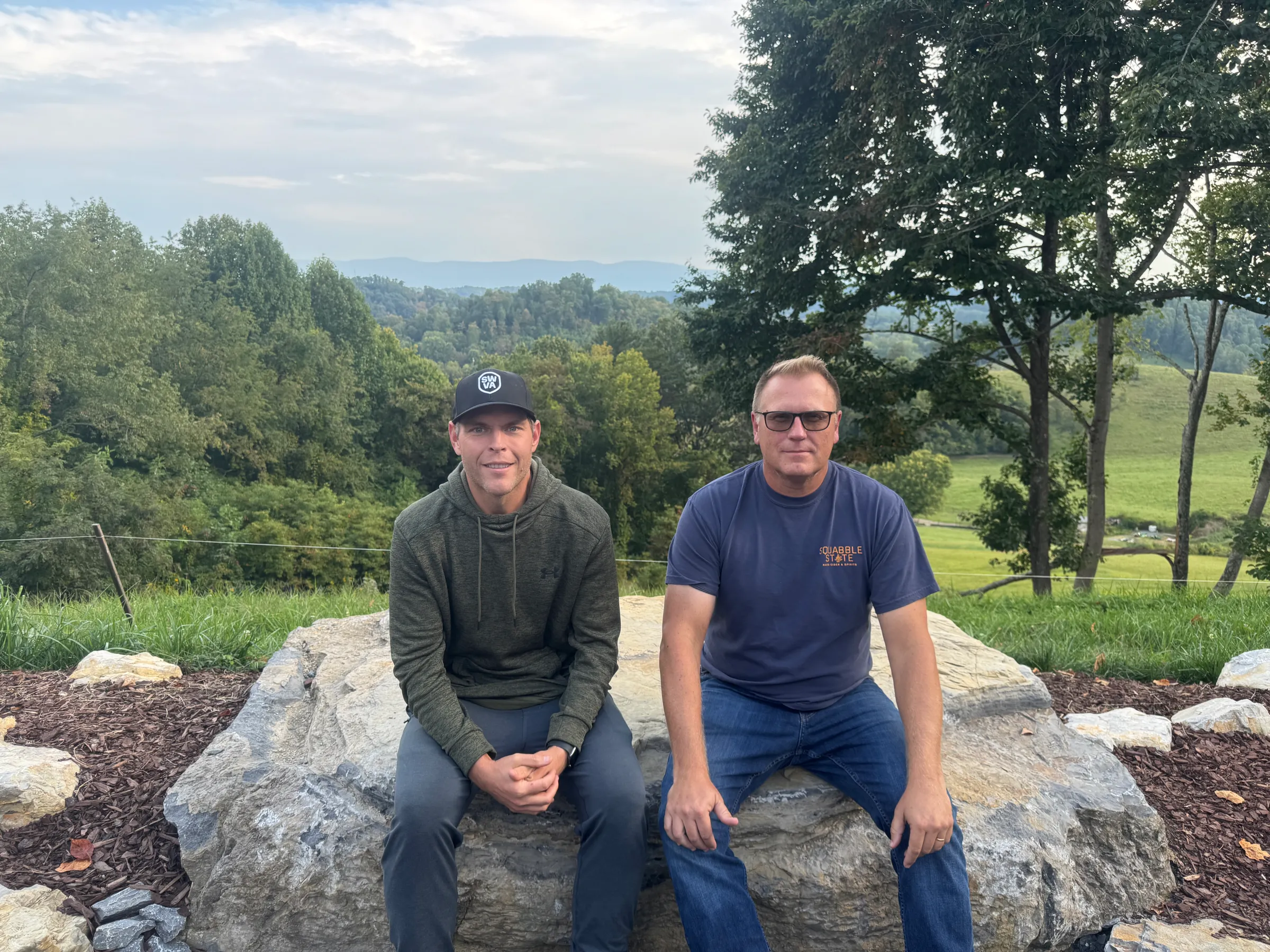 Will Payne (L) and Will Clear (R) of Energy DELTA Lab are pictured outside of Squabble State Hard Cider & Spirits in Bristol, Virginia, USA, September 16, 2025. David Sherfinski/Thomson Reuters Foundation