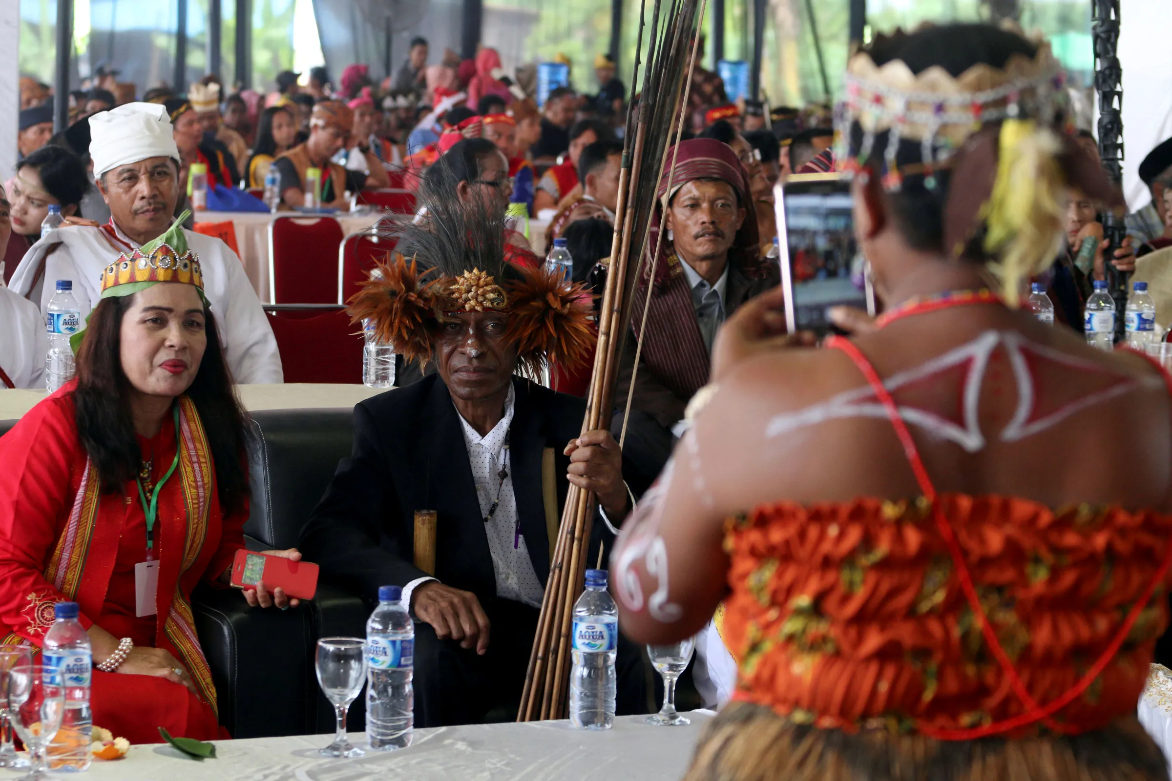 Participants take photos on the sidelines of an indigenous people's gathering, near Medan, Sumatra Island, Indonesia March 17, 2017.