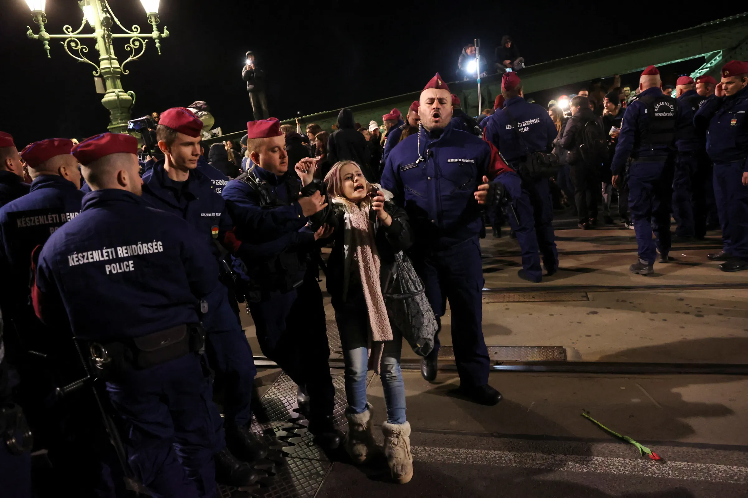 Police officers hold a protester during a demonstration after Hungarian parliament passed a law that will ban LGBTQ+ communities from holding their annual Pride march in Budapest, Hungary, April 8, 2025. REUTERS/Bernadett Szabo