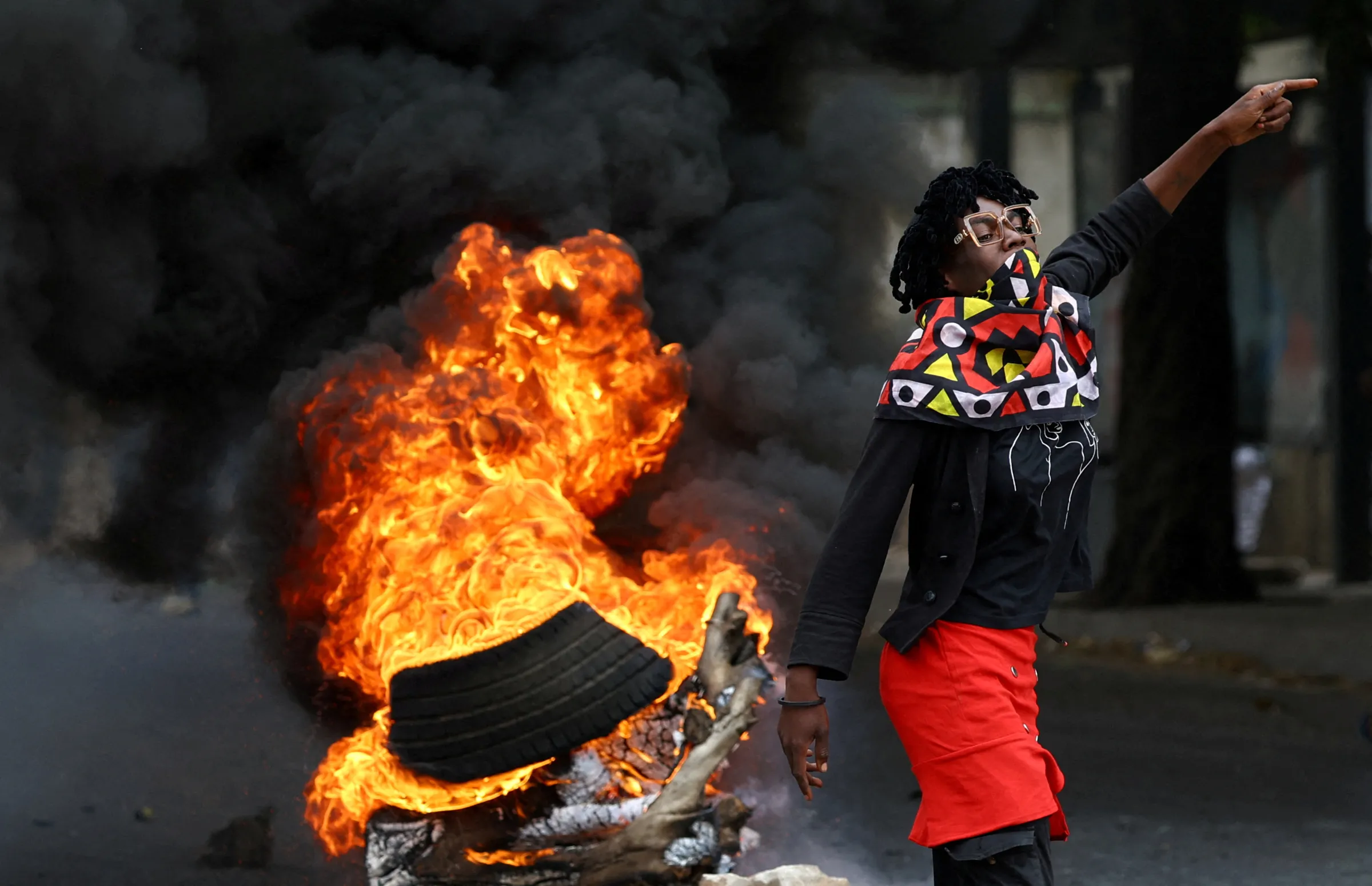 A protester reacts near a burning barricade during a 'national shutdown' against the election outcome, at Luis Cabral township in Maputo, Mozambique, November 7, 2024. REUTERS/Siphiwe Sibeko