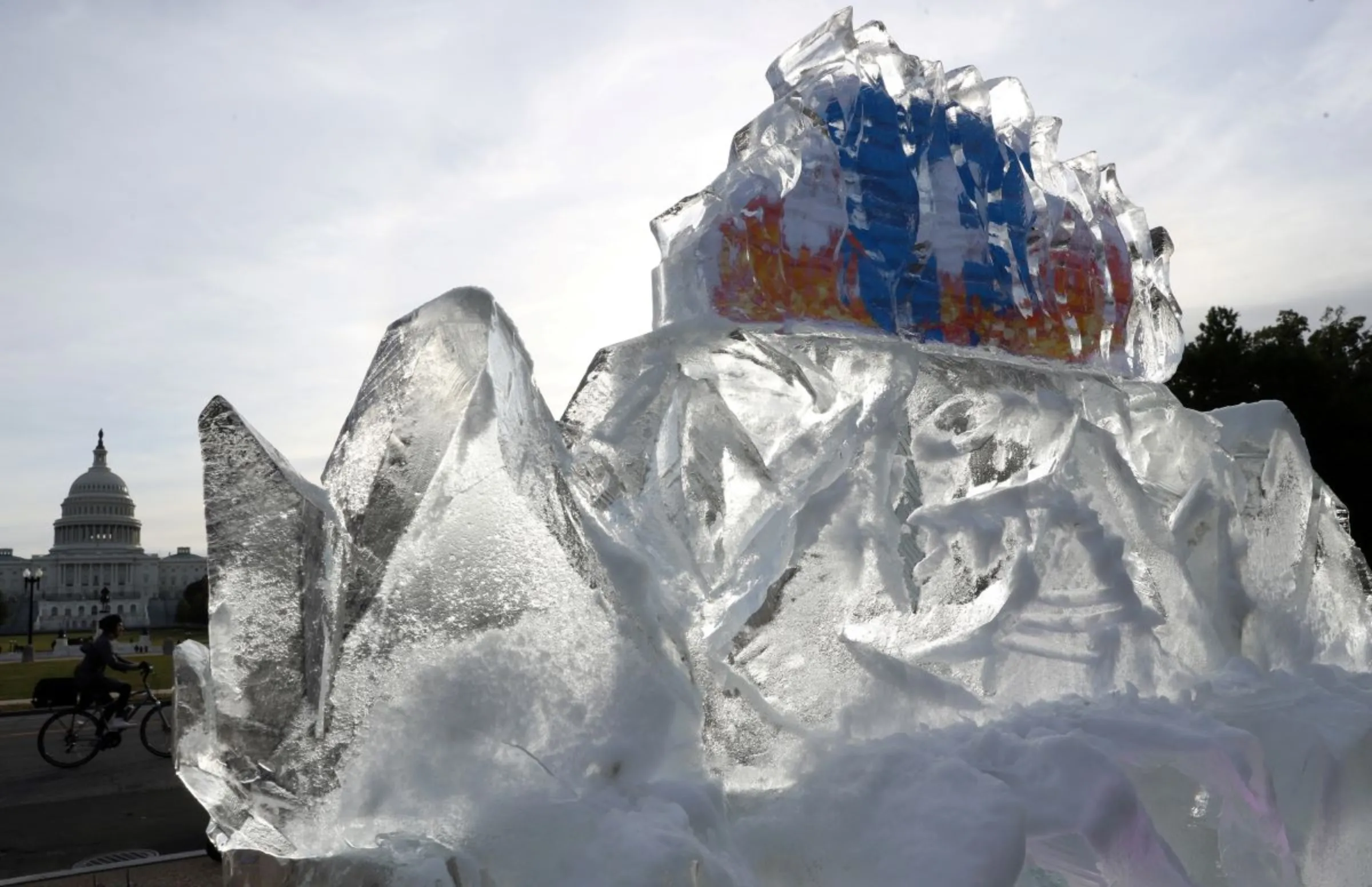 An ice sculpture with Facebook’s logo embedded on the inside melts near the U.S. Capitol building, as part of a protest over Facebook’s role in the spread of climate misinformation online in Washington, U.S., November 4, 2021