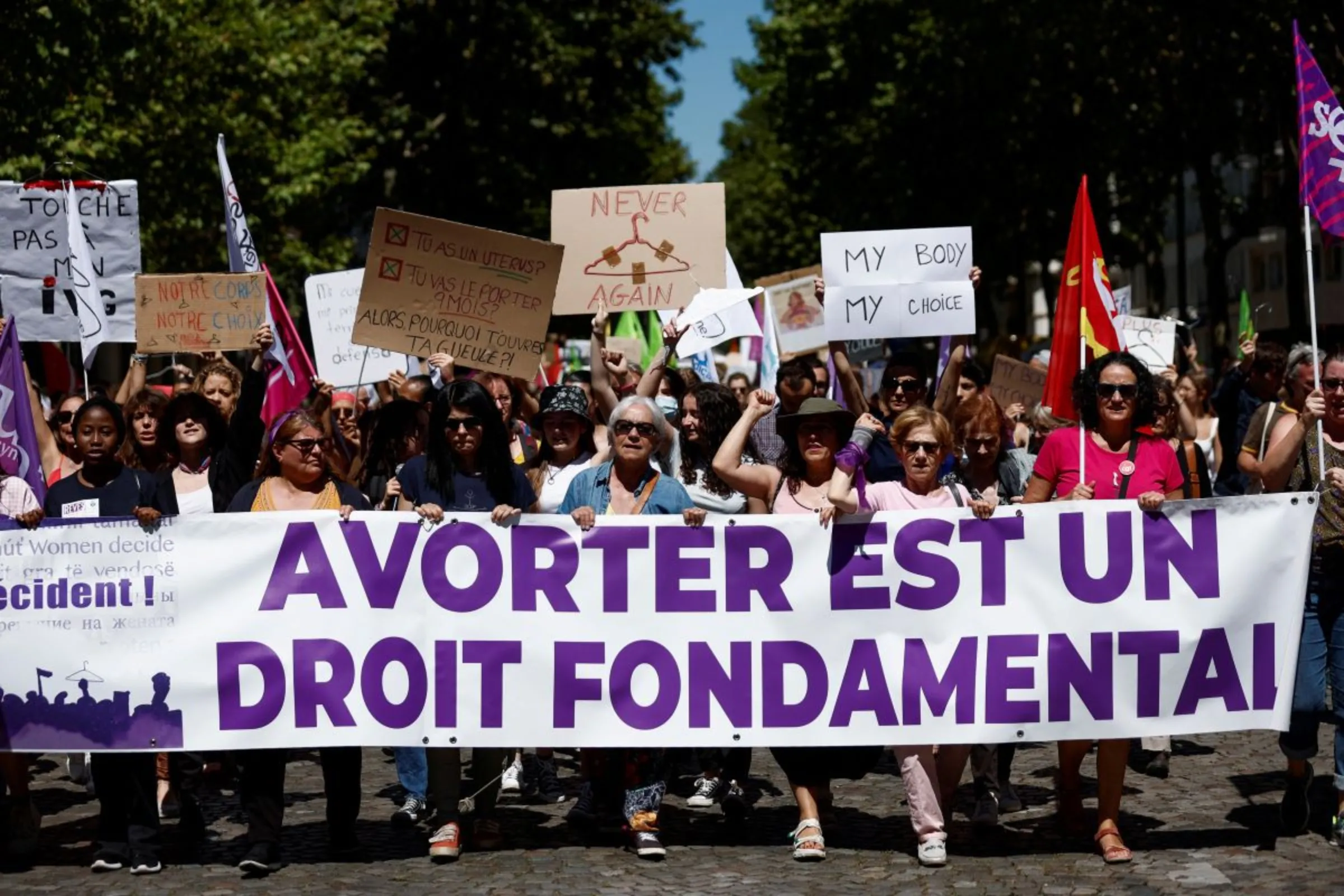 Protesters hold a banner reading 'abortion is a basic right' during a rally in support of abortion rights following the U.S. Supreme Court overturning Roe v. Wade, in Paris, France, July 2, 2022