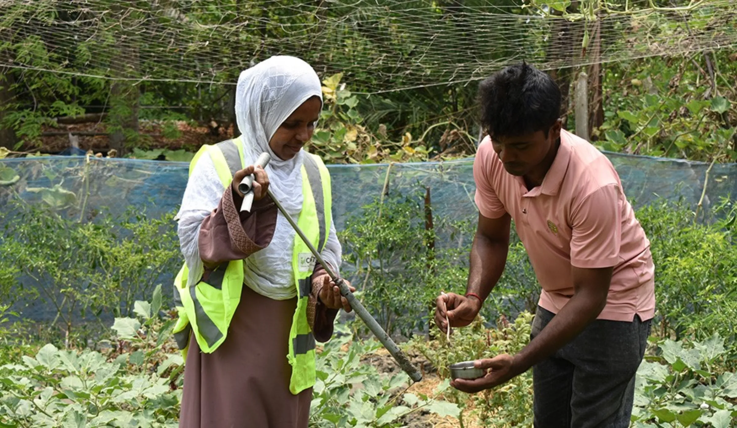 Farmer trainer Sabekun Nahar and a Cordaid volunteer collect soil samples to test for salinity on a farm near Rampal, Bangladesh. Rachel Parsons/Thomson Reuters Foundation