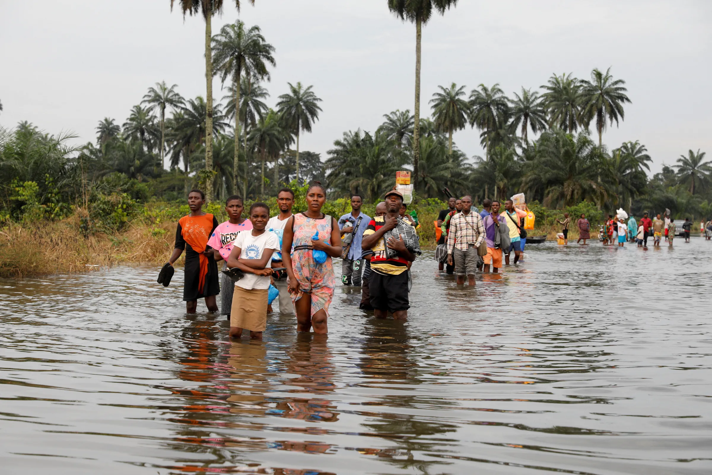 Residents wade through flood water in Obagi community, Rivers state, Nigeria October 21, 2022. REUTERS/Temilade Adelaja