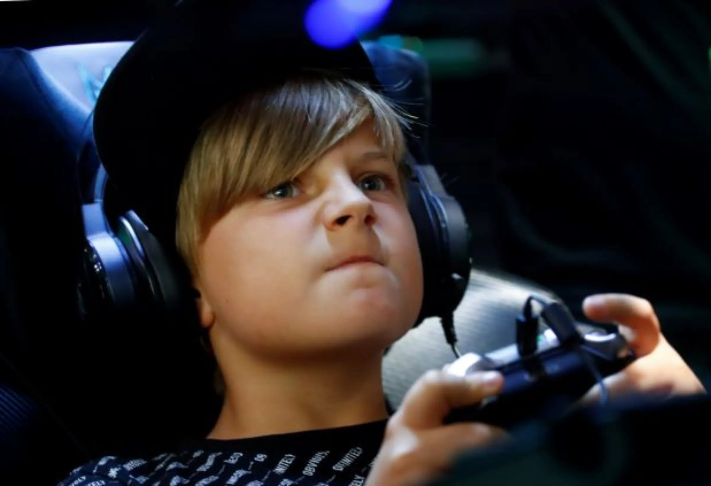 A boy reacts as he plays a game during the first day of Europe's leading digital games fair Gamescom, which showcases the latest trends of the computer gaming scene in Cologne, Germany, August 21, 2019. REUTERS/Wolfgang Rattay