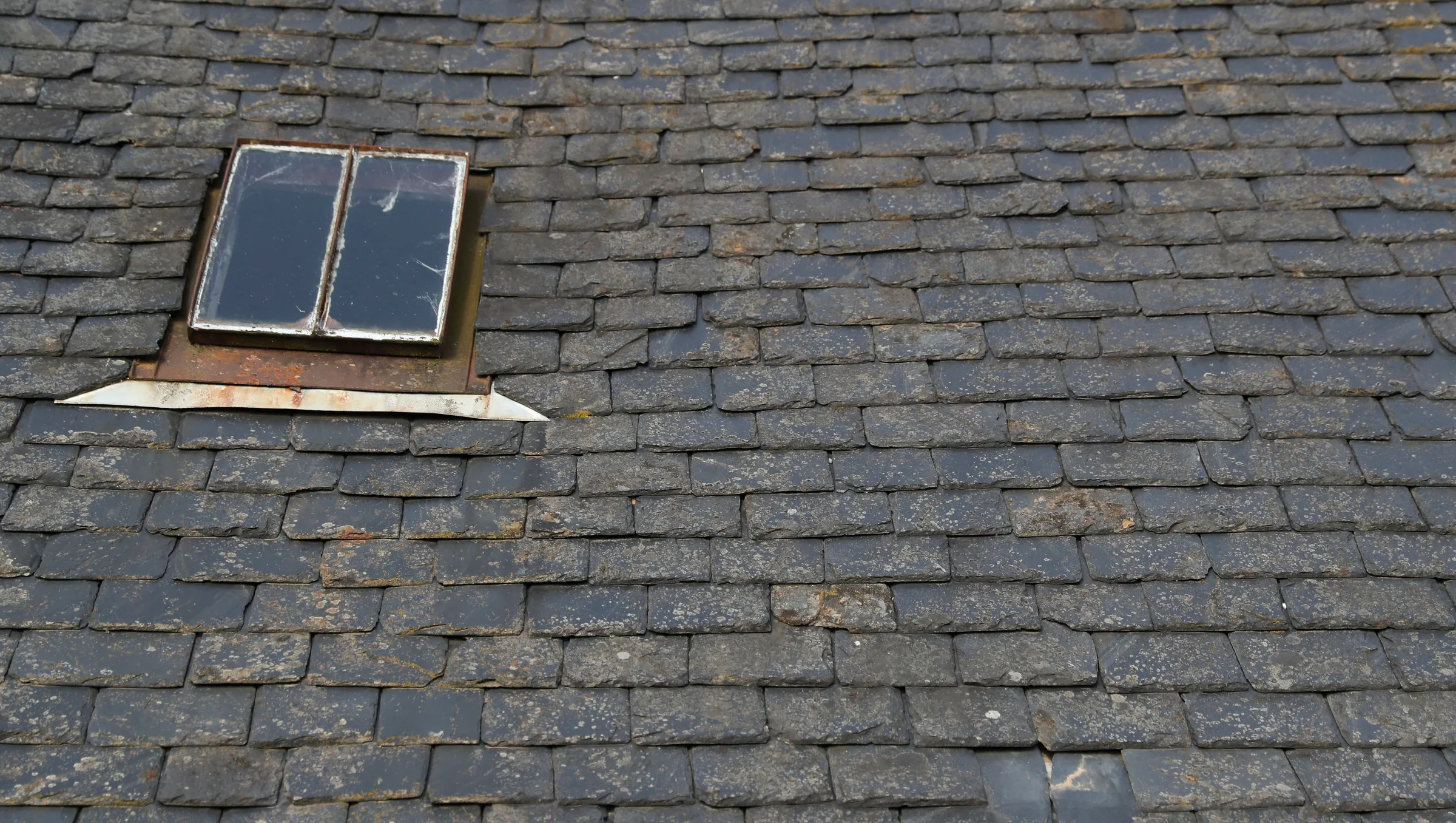 A view of the slate roof of an old building on the Bunloit Rewilding estate, Scotland