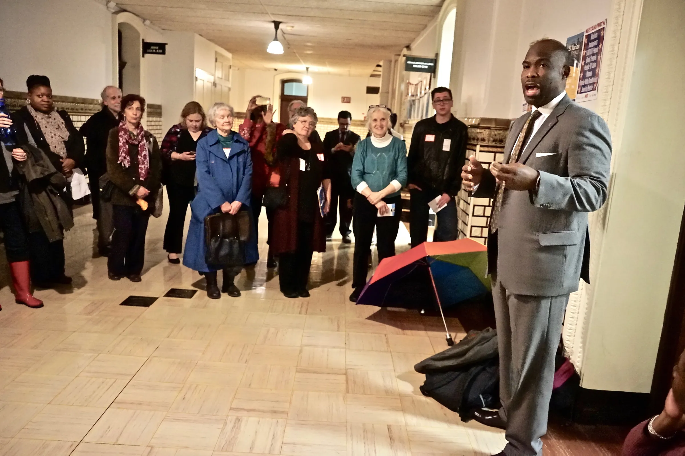 Philadelphia city councilmember Derek Green discusses a public bank proposal with supporters outside his office in 2019