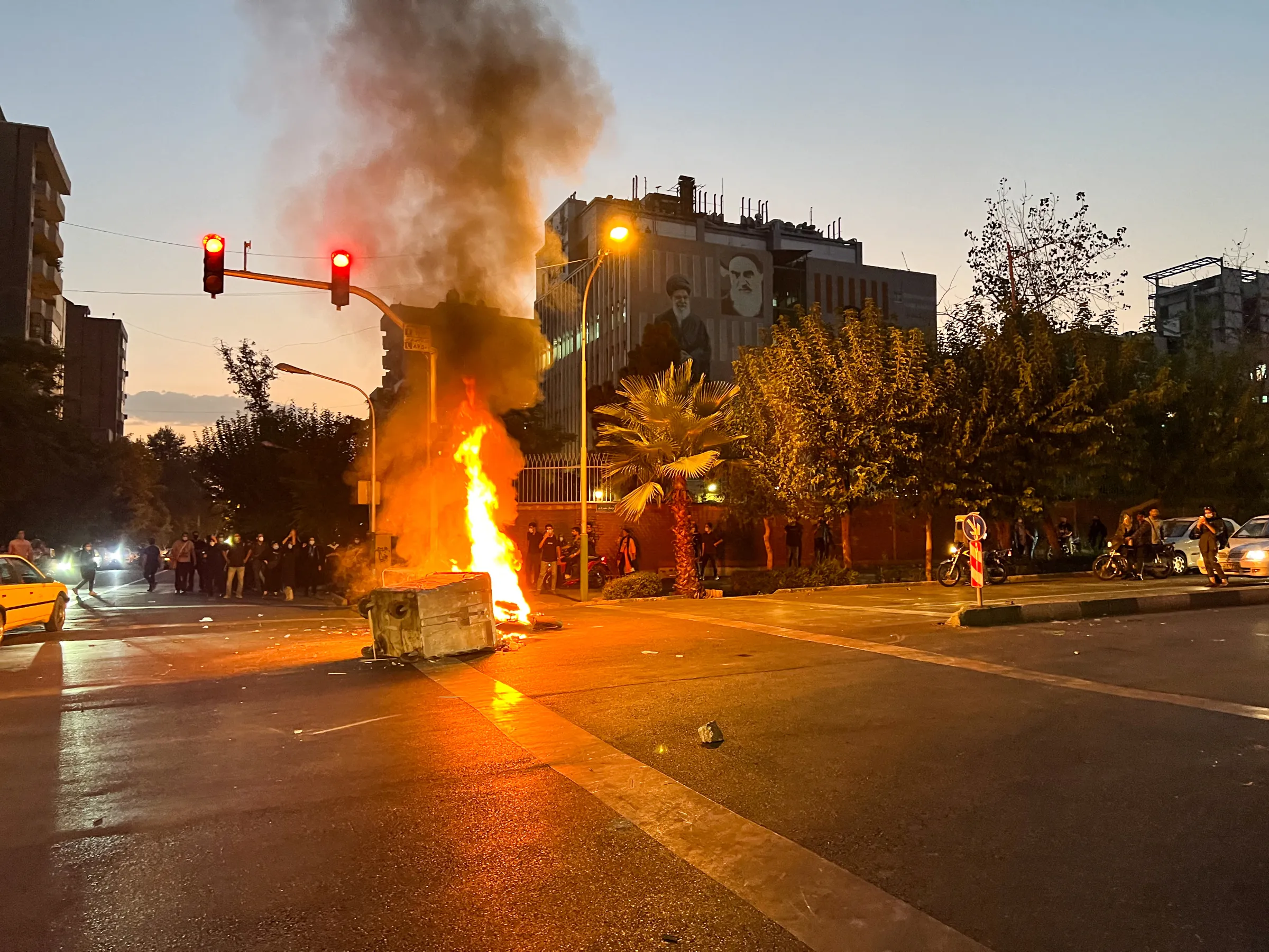 A police motorcycle burns during a protest over the death of Mahsa Amini, a woman who died after being arrested by the Islamic republic's 'morality police', in Tehran, Iran September 19, 2022. WANA (West Asia News Agency) via REUTERS