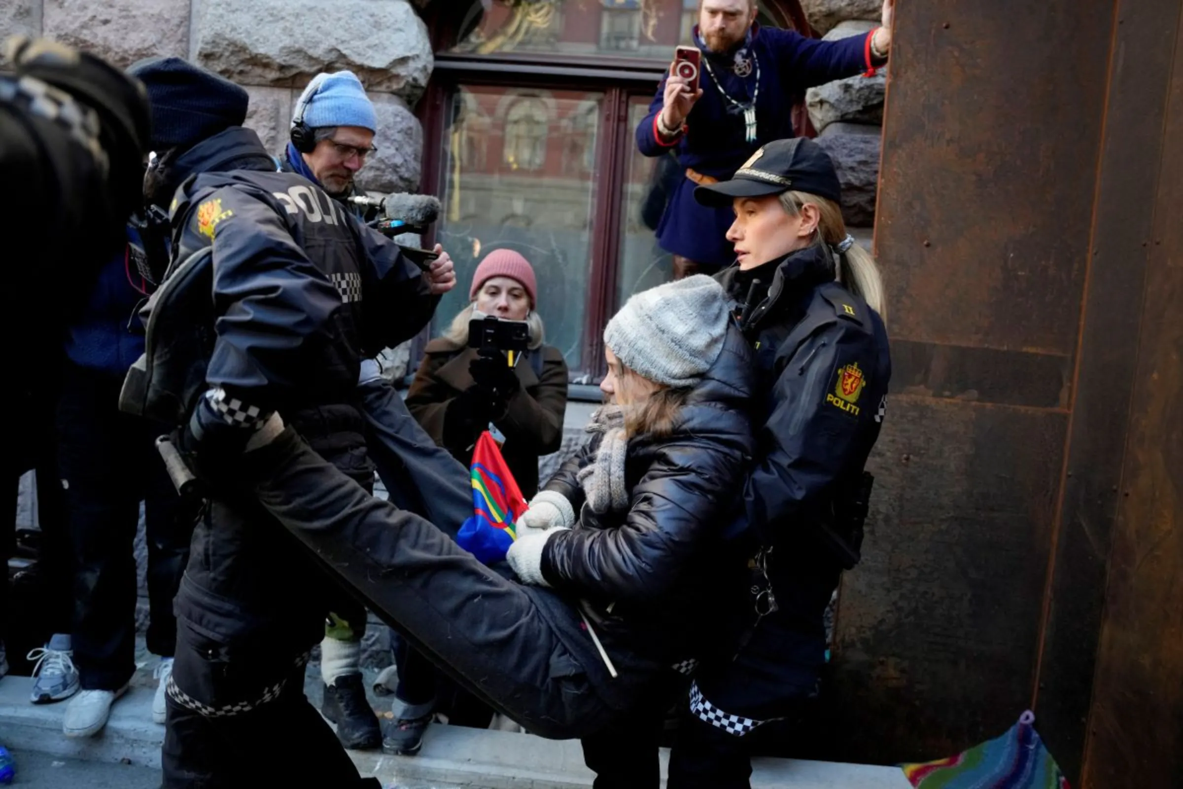 Greta Thunberg is carried away by police officers as activits demonstrate outside the Ministry of Finance entrance and several other ministries in protest against the Fosen wind turbines not being demolished, which was built on land traditionally used by indigenous Sami reindeer herders, in Oslo, Norway, March 1, 2023. Alf Simensen/NTB/via REUTERS