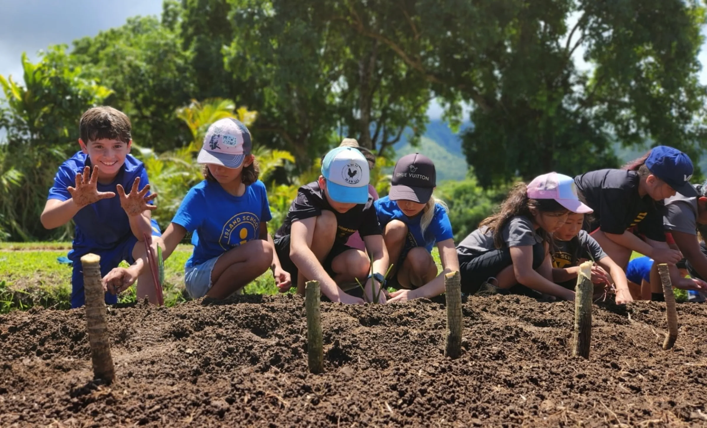 Students help plant along a traditional waterway on the Hawaiian island of Kauaiʻi in 2025. Kelsey Rogers/Waipa Foundation/Handout via Thomson Reuters Foundation