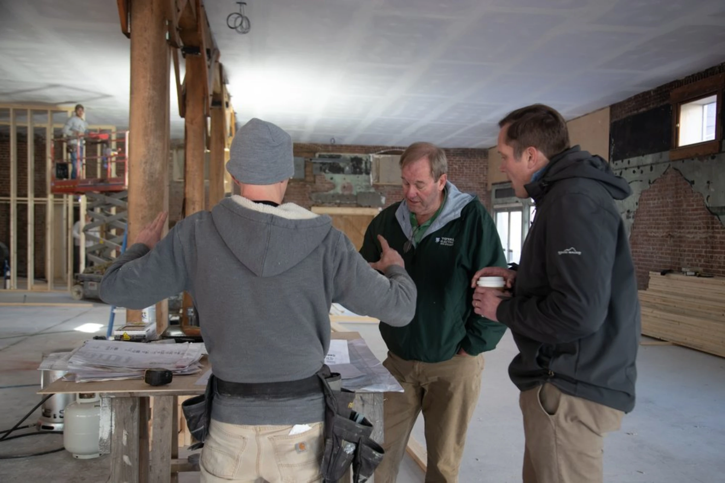 Businessman Geoff Marietta talks with his employees about the construction of the new brewery in Harlan, Kentucky, January 26, 2022. Thomson Reuters Foundation/Amira Karaoud