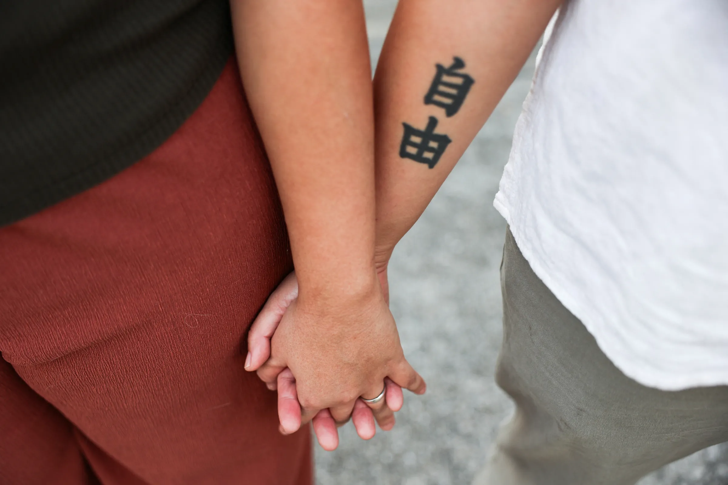 A lesbian couple hold hands the day before they register marriage certificates in Bangkok, Thailand, January 22, 2025. REUTERS/Chalinee Thirasupa