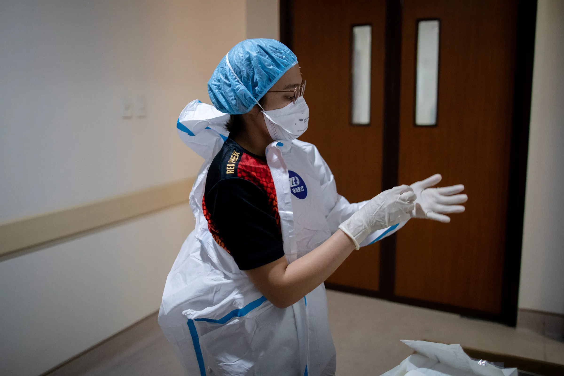 A doctor puts on personal protective equipment in the Emergency Room of East Avenue Medical Center, in Quezon City, Metro Manila, Philippines, June 26, 2020. REUTERS/Eloisa Lopez