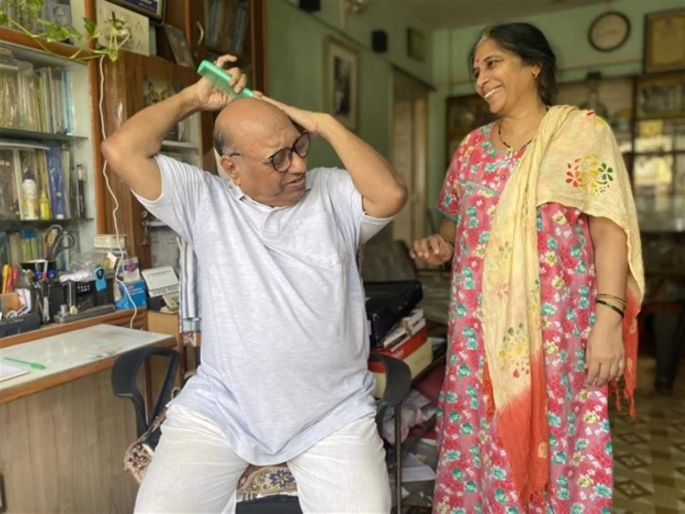 Dalit archivist Vijay Surwade and his wife Mangala talk in their apartment in Kalyan on May 11, 2023. Thomson Reuters Foundation/Vidhi Doshi