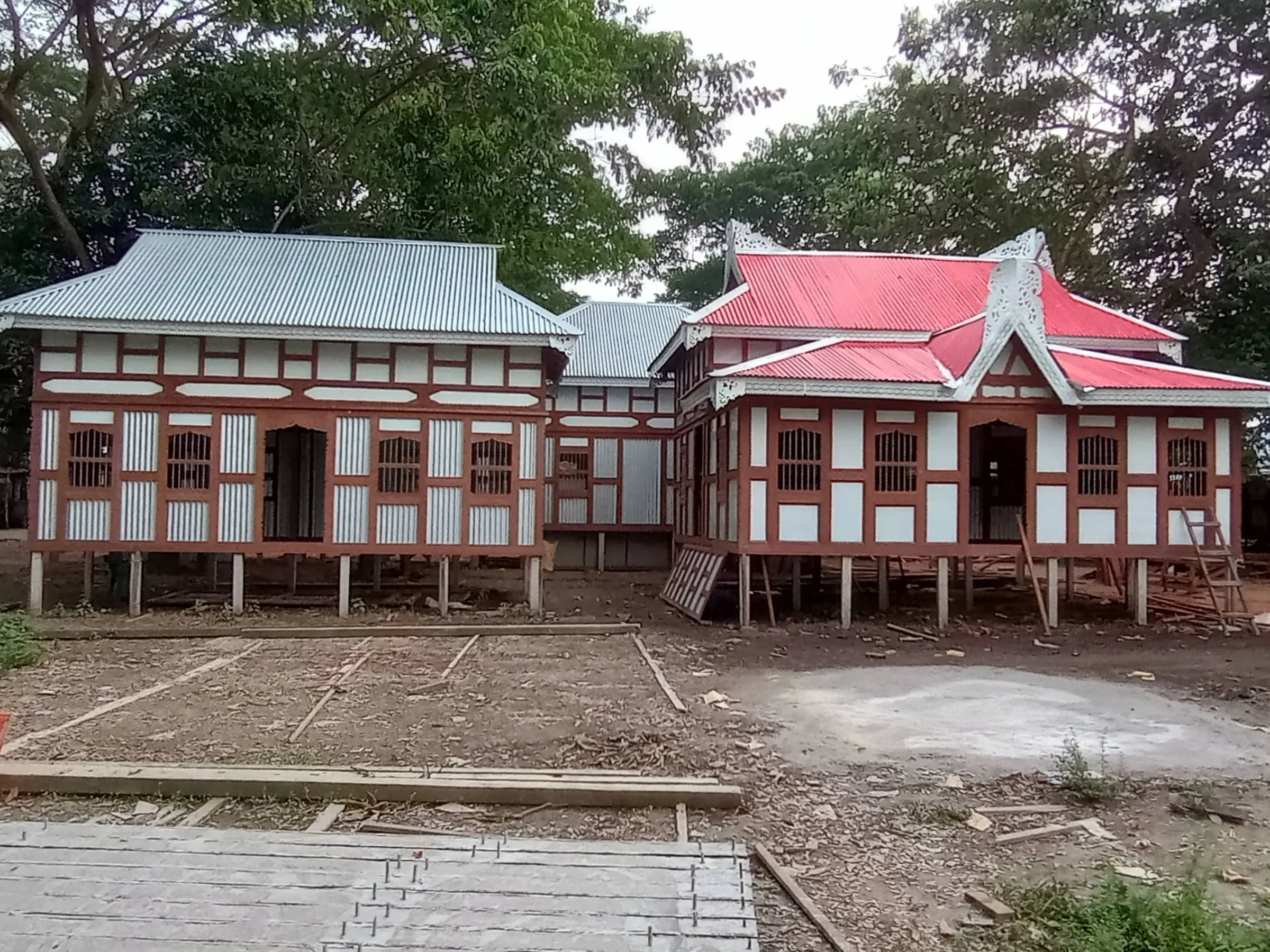 Pre-built wooden houses, which can be raised to adapt to rising water levels in monsoon season, on the banks of the Kajalrekha River in Munshiganj district, Bangladesh, September 30, 2022