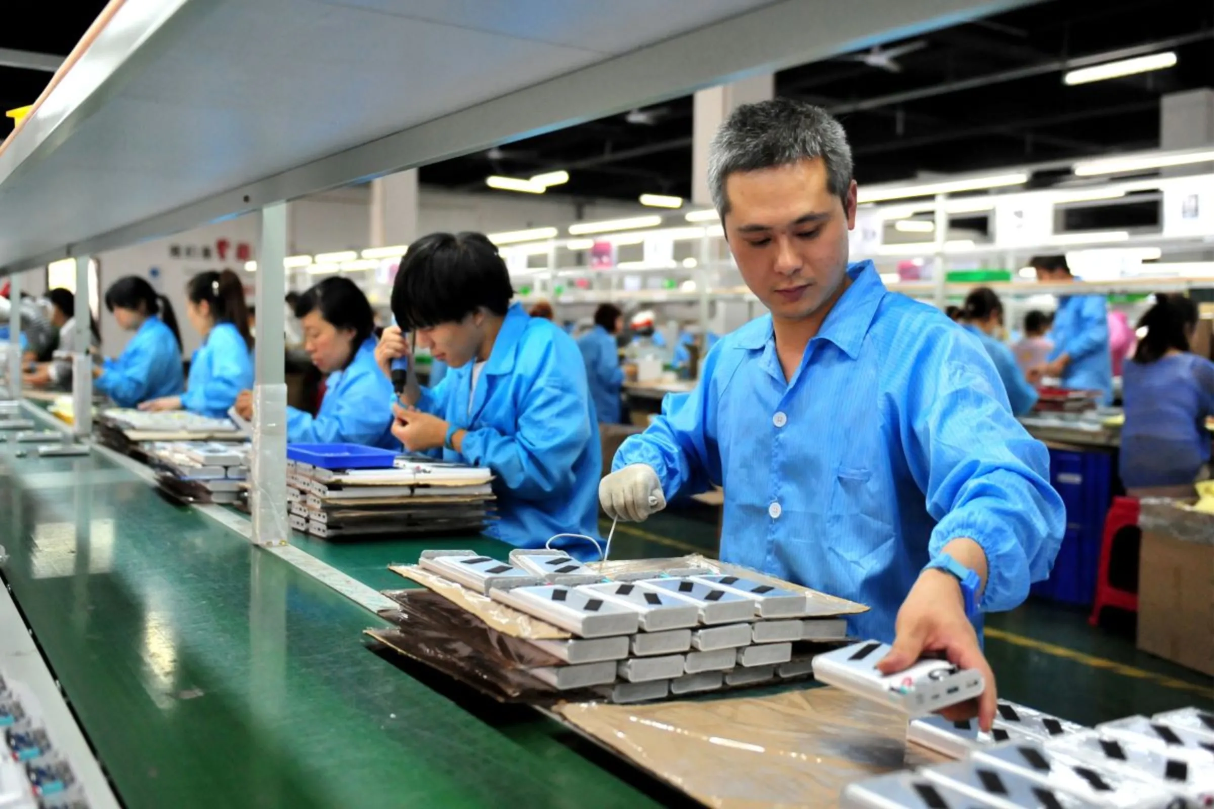 Employees work on a production line manufacturing lithium battery products at a factory in Yichang, Hubei province, China May 28, 2019