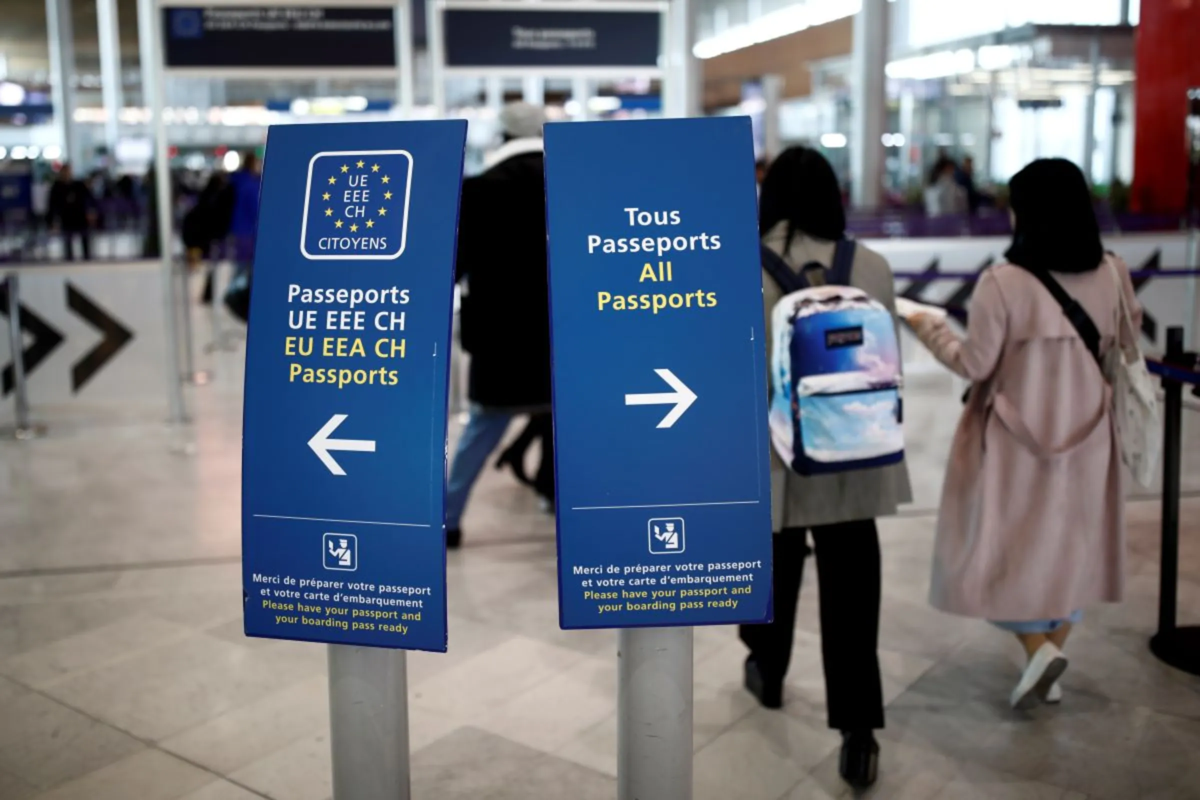 Directional signs for passport control are seen at Charles de Gaulle airport, operated by Aeroports de Paris, in Roissy, France, April 11, 2019. REUTERS/Benoit Tessier