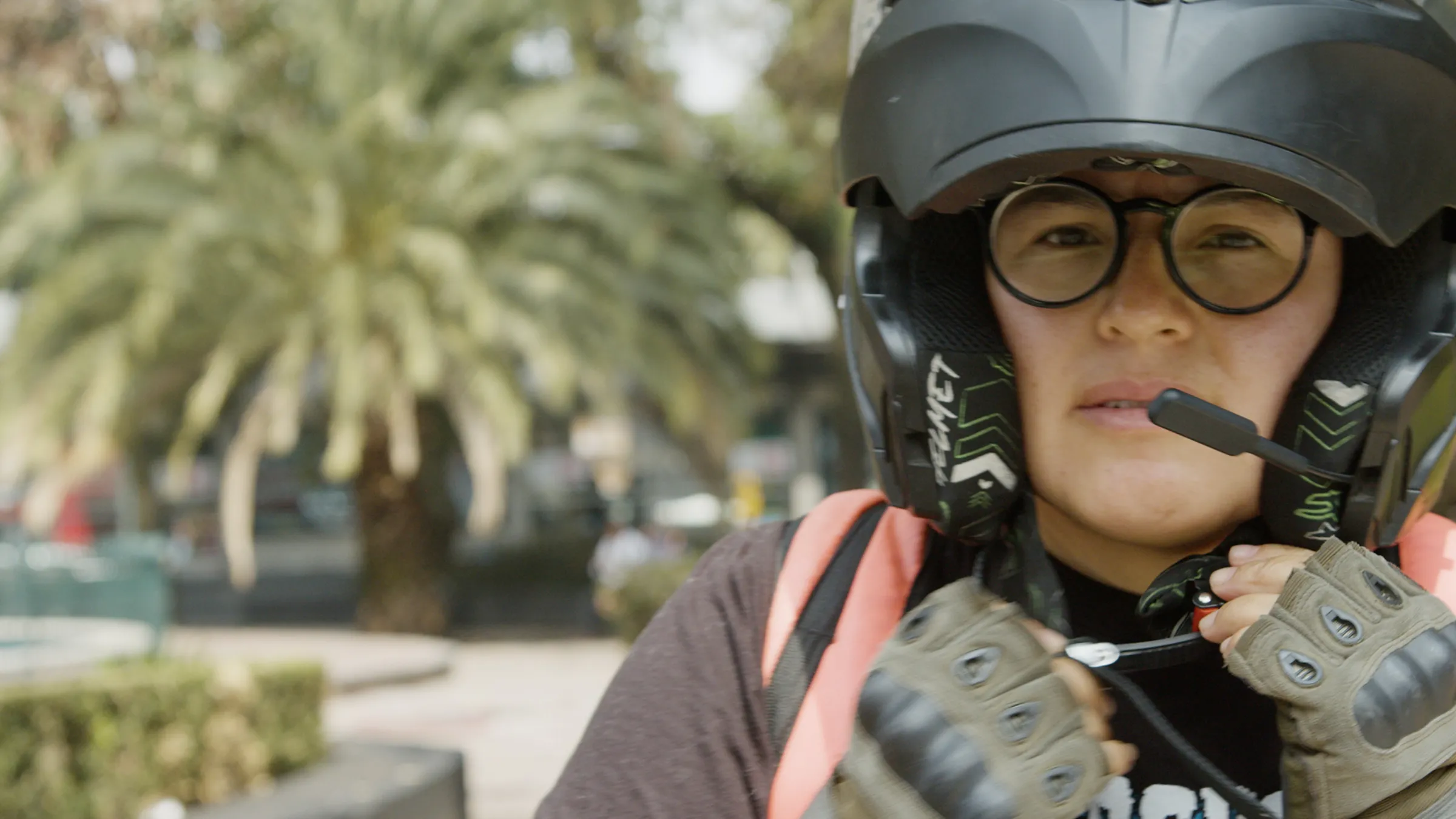 A gig worker takes of their helmet in this screengrab for the Context video 'Mexico is pushing for sweeping gig worker rights. Women say it’s not enough'.