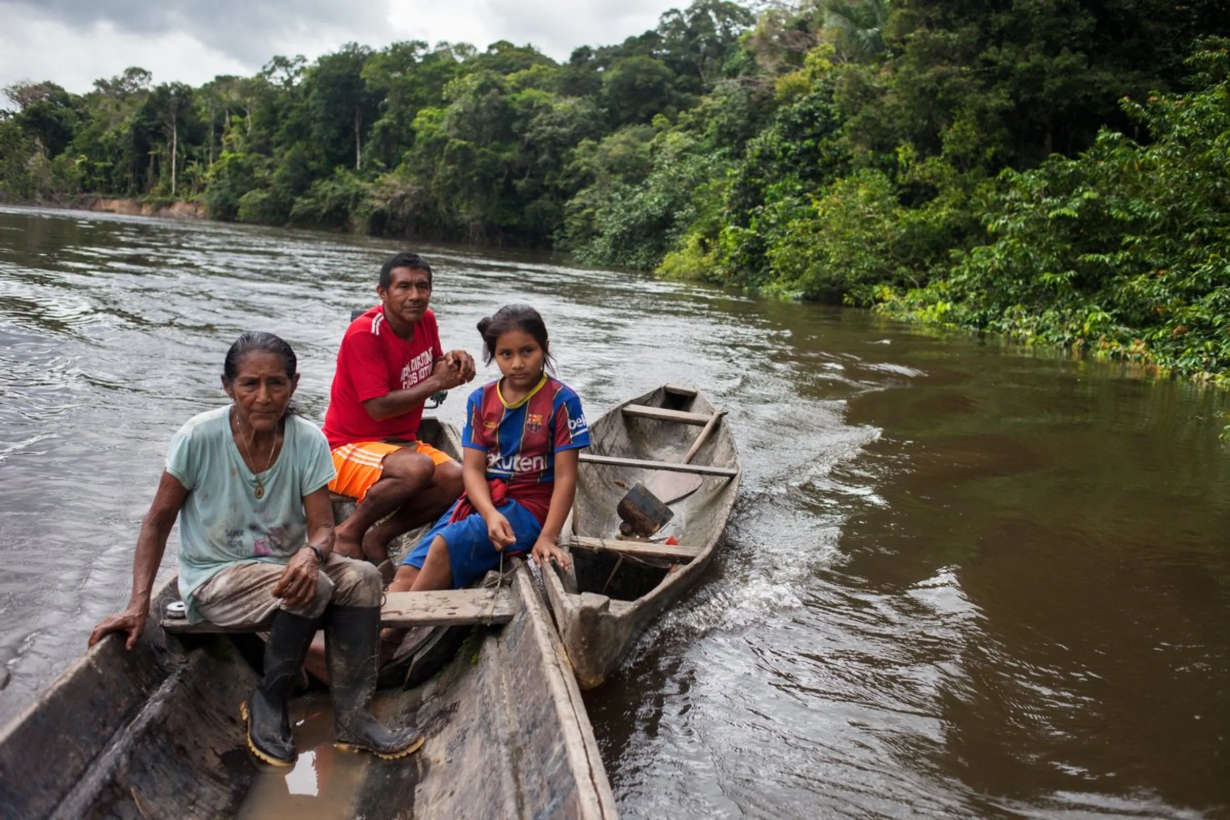 Lucio Matapi, 'captain' of the Puerto Libre community, (at the rear) travels with other residents as they fish along the Miriti-Parana River in Colombia’s southeast Amazonas province, December 19, 2021