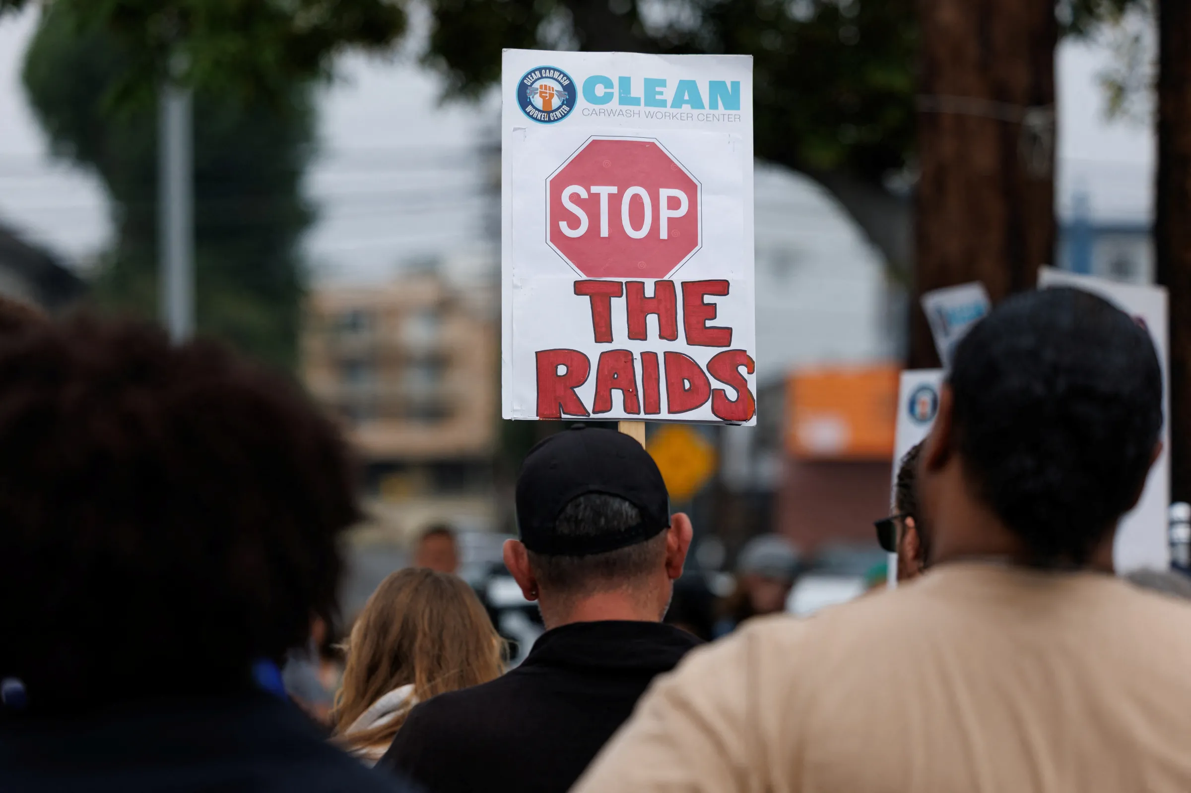 A supporter holds a sign as relatives of people who were taken into custody by ICE at a car wash gather to call for their immediate release, in Culver City, California, U.S. June 11, 2025. REUTERS/Mike Blake