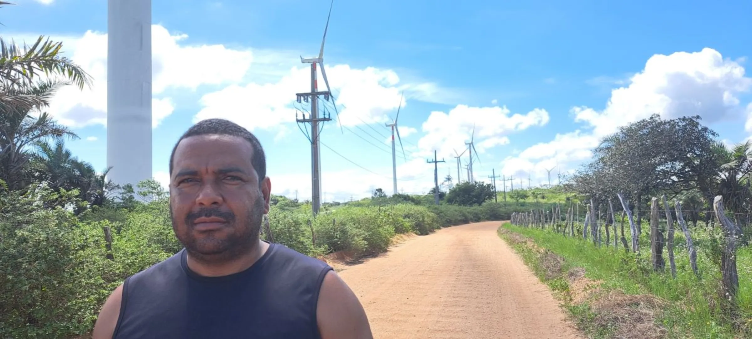 Zenivaldo Bezerra, leader of the Entre Serras Pankararu people, poses for a picture next to a wind tower about 50 meters from his land in Pernambuco, Brazil, May 12, 2023. Fabio Teixeira/Thomson Reuters Foundation