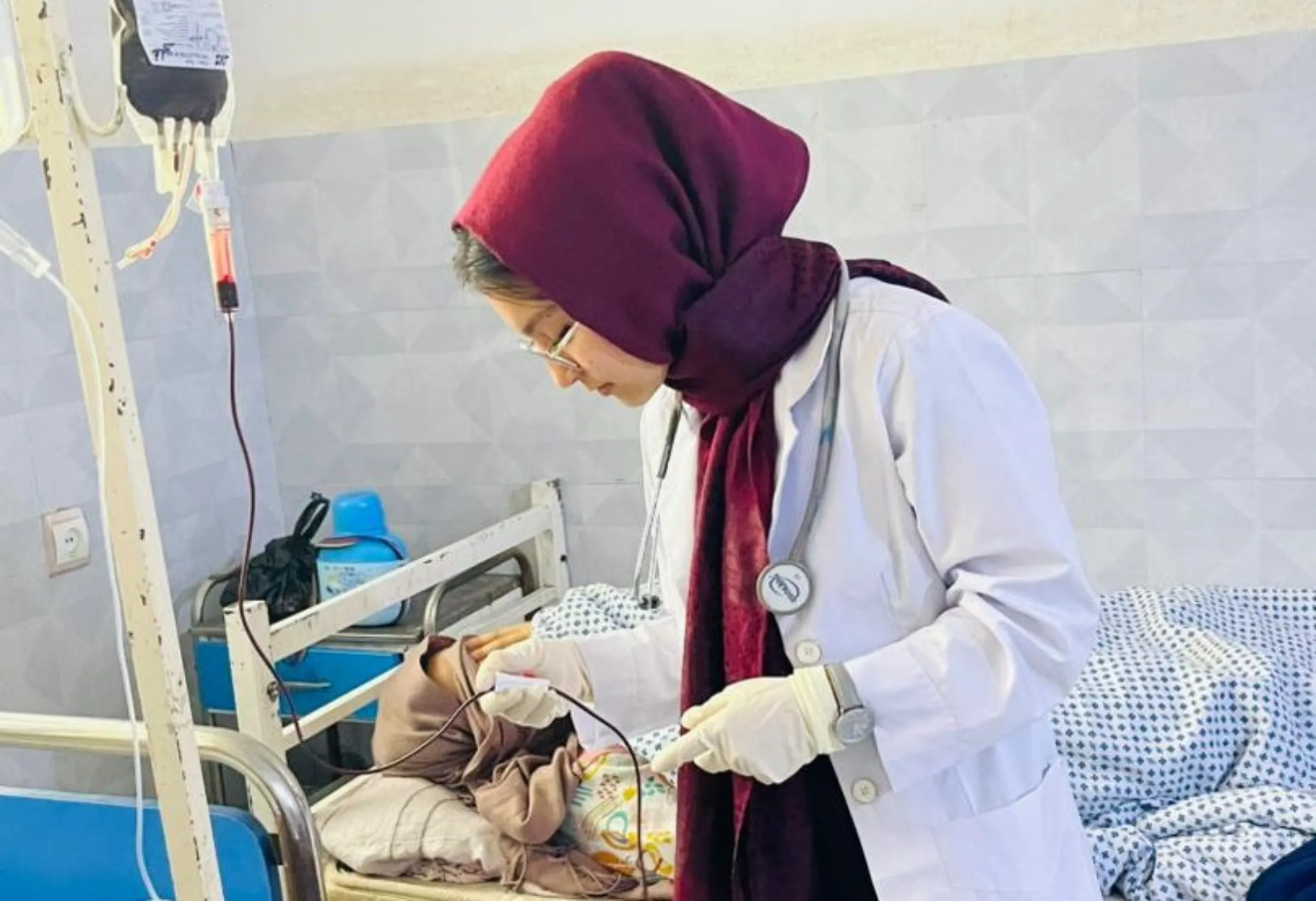 Student nurse Marwa Azimi attends to a patient during a clinical placement in Badakhshan province. Handout via Thomson Reuters Foundation