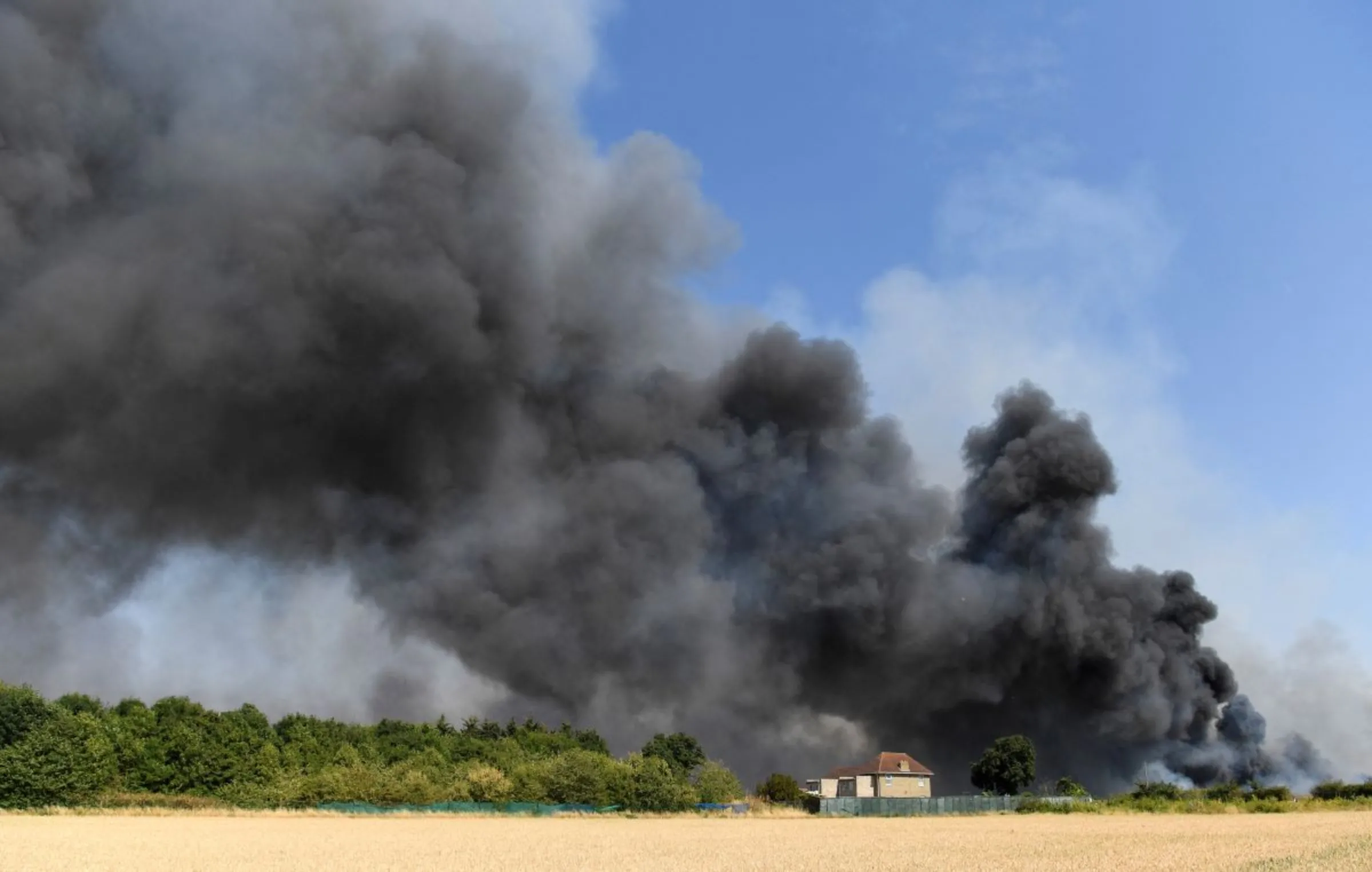 A fire burns during a heatwave, in Rainham, east London, Britain, July 19, 2022