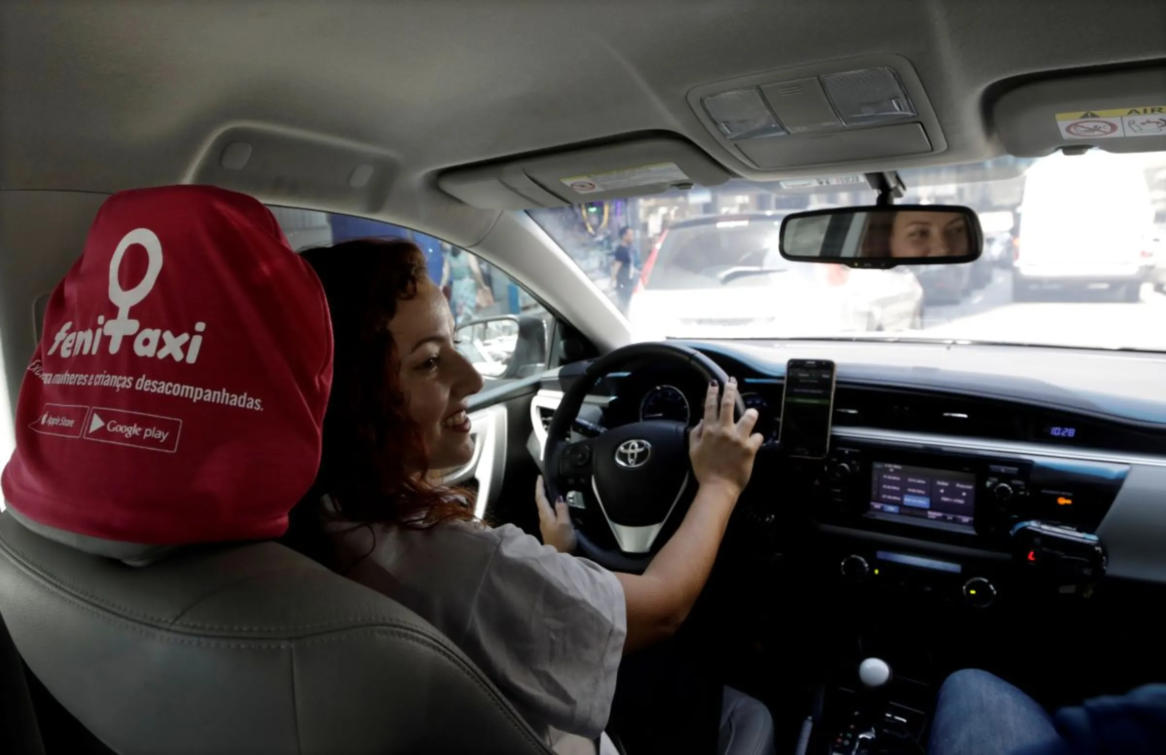 A taxi driver drives her car in a main street in Sao Paulo, Brazil October 10, 2017