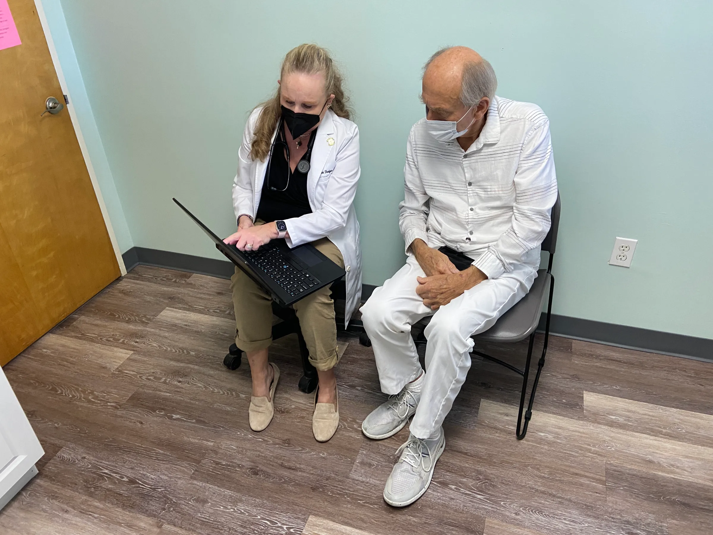 Nurse practitioner Alexis Hodges chats with patient Charles Nathaniel Smith at the Community Care Clinic of Dare in Nags Head, North Carolina, USA, September 7, 2022. Thomson Reuters Foundation/David Sherfinski