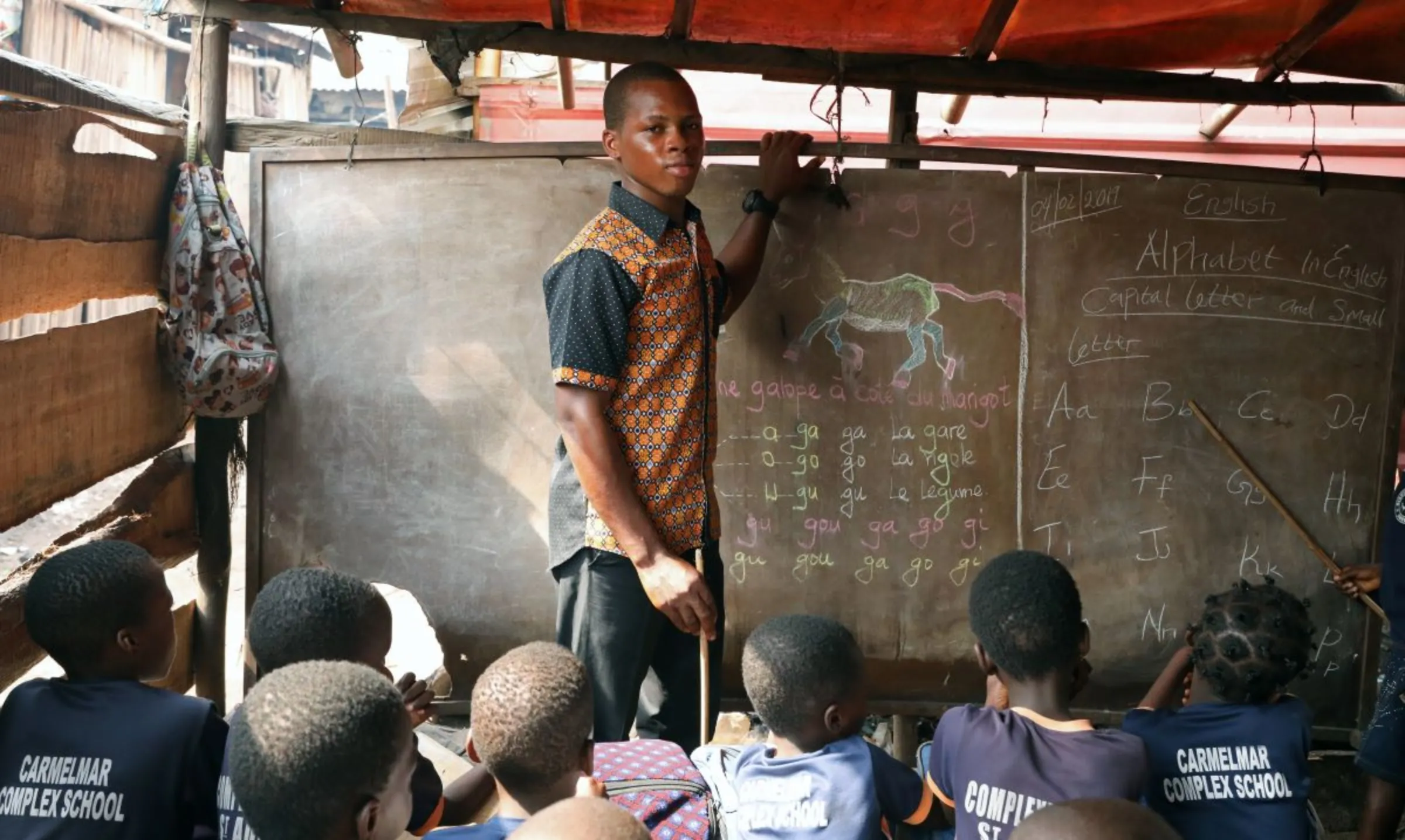 Teacher poses for a picture in his classroom in the Makoko shanty town built on stilts in a lagoon in Lagos, Nigeria February 4, 2019. REUTERS/Temilade Adelaja