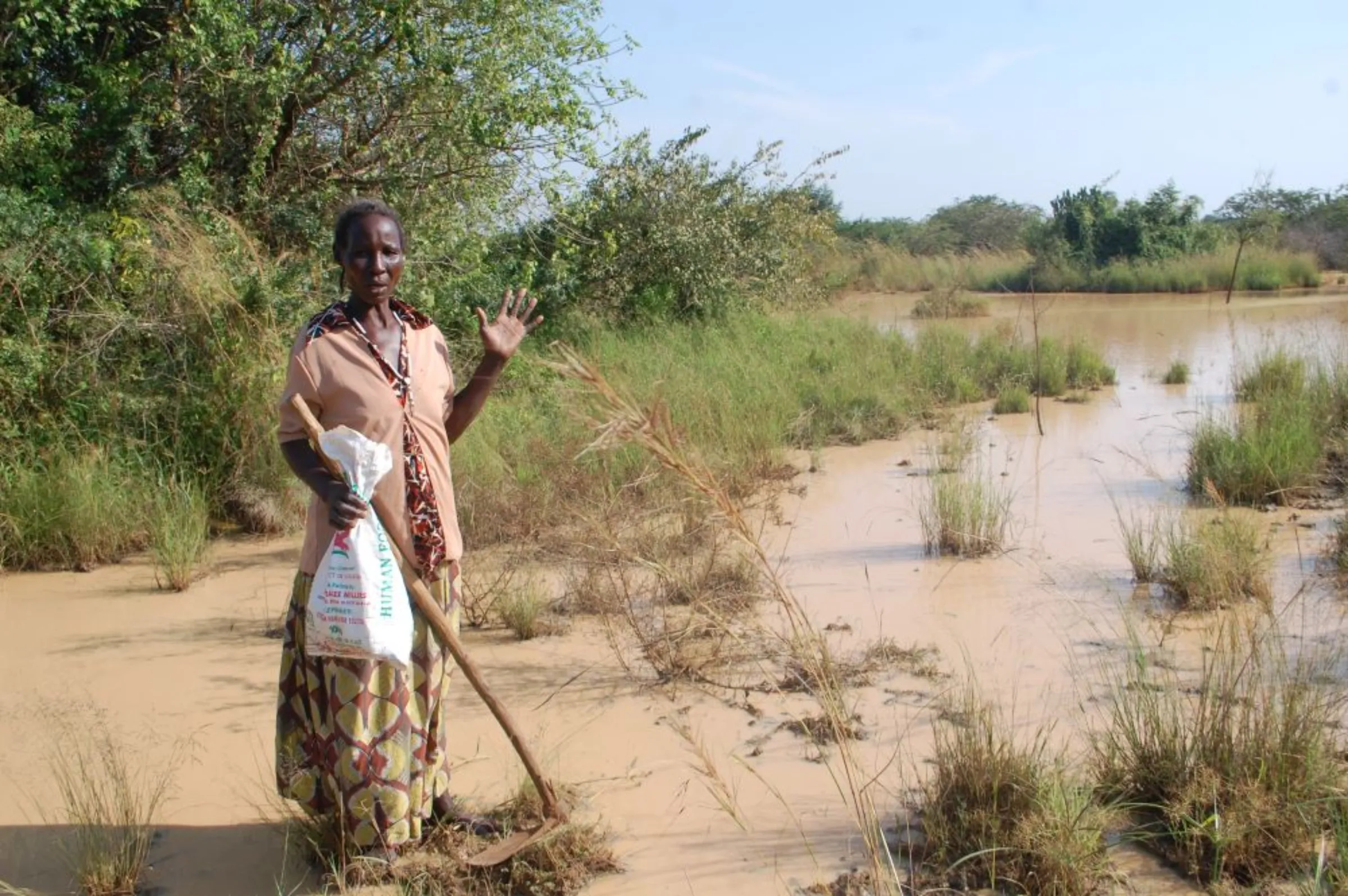 A farmer stands in her garden affected by floods in Kasenyi village, Uganda, December 16, 2022