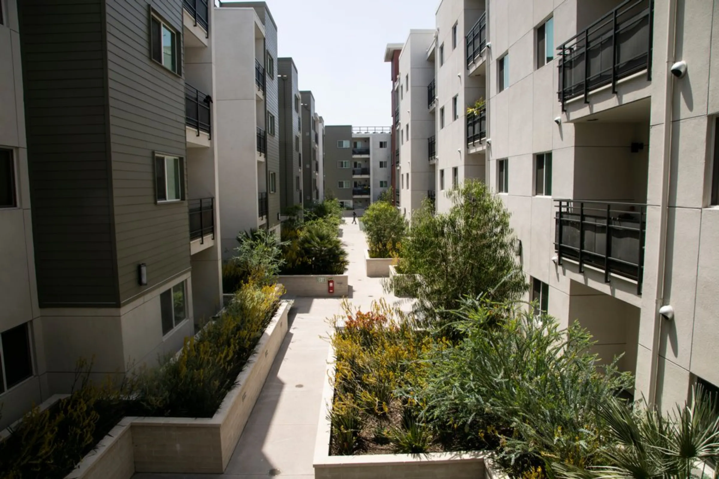 A view of an affordable housing residential development financed with state funds from a carbon tax and built next to a train station in Los Angeles, May 19, 2021
