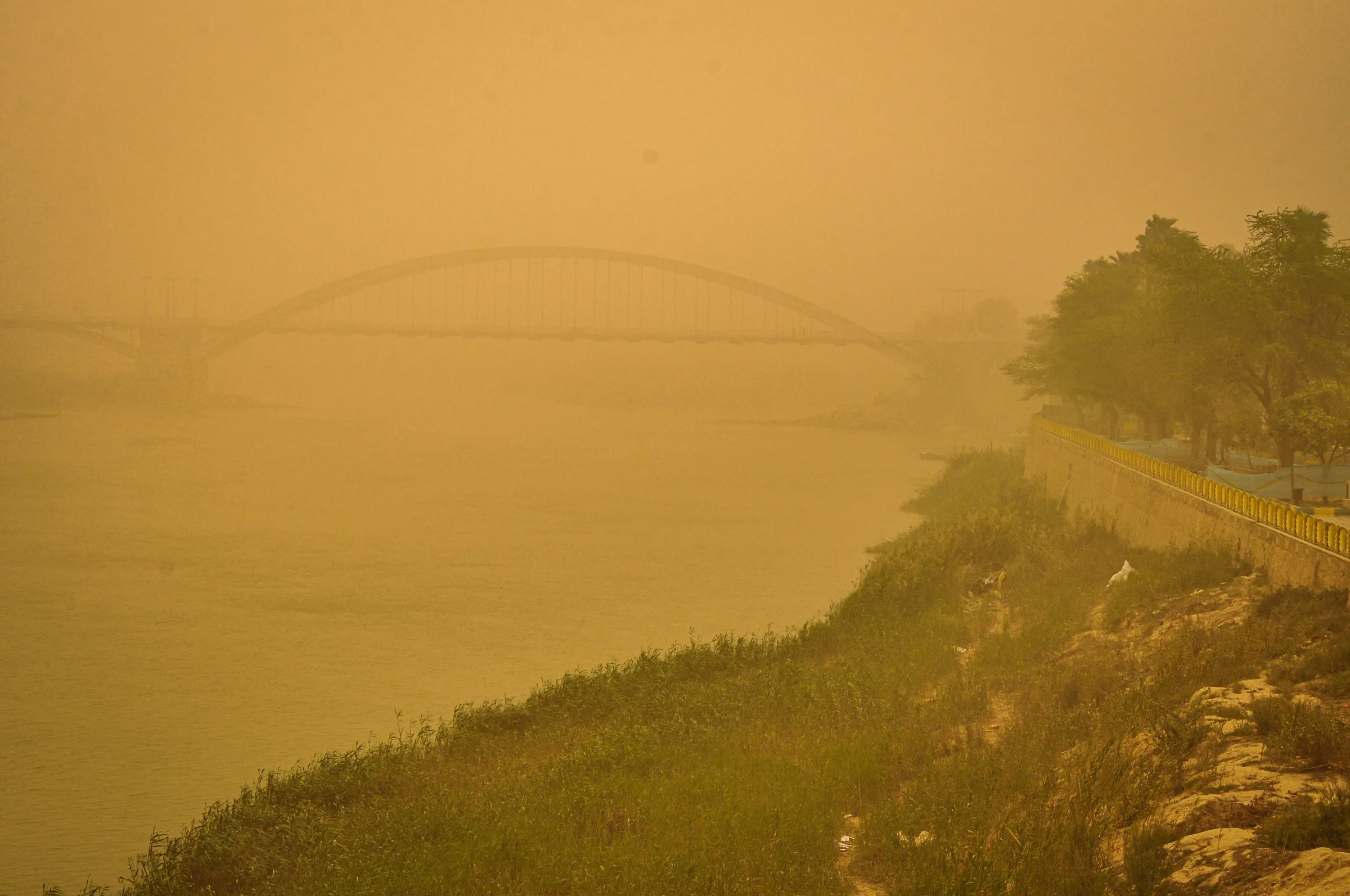 A bridge over the Karun river is blanketed in a thick haze during one of the increasingly frequent and intense sand and dust storms hitting the Middle East