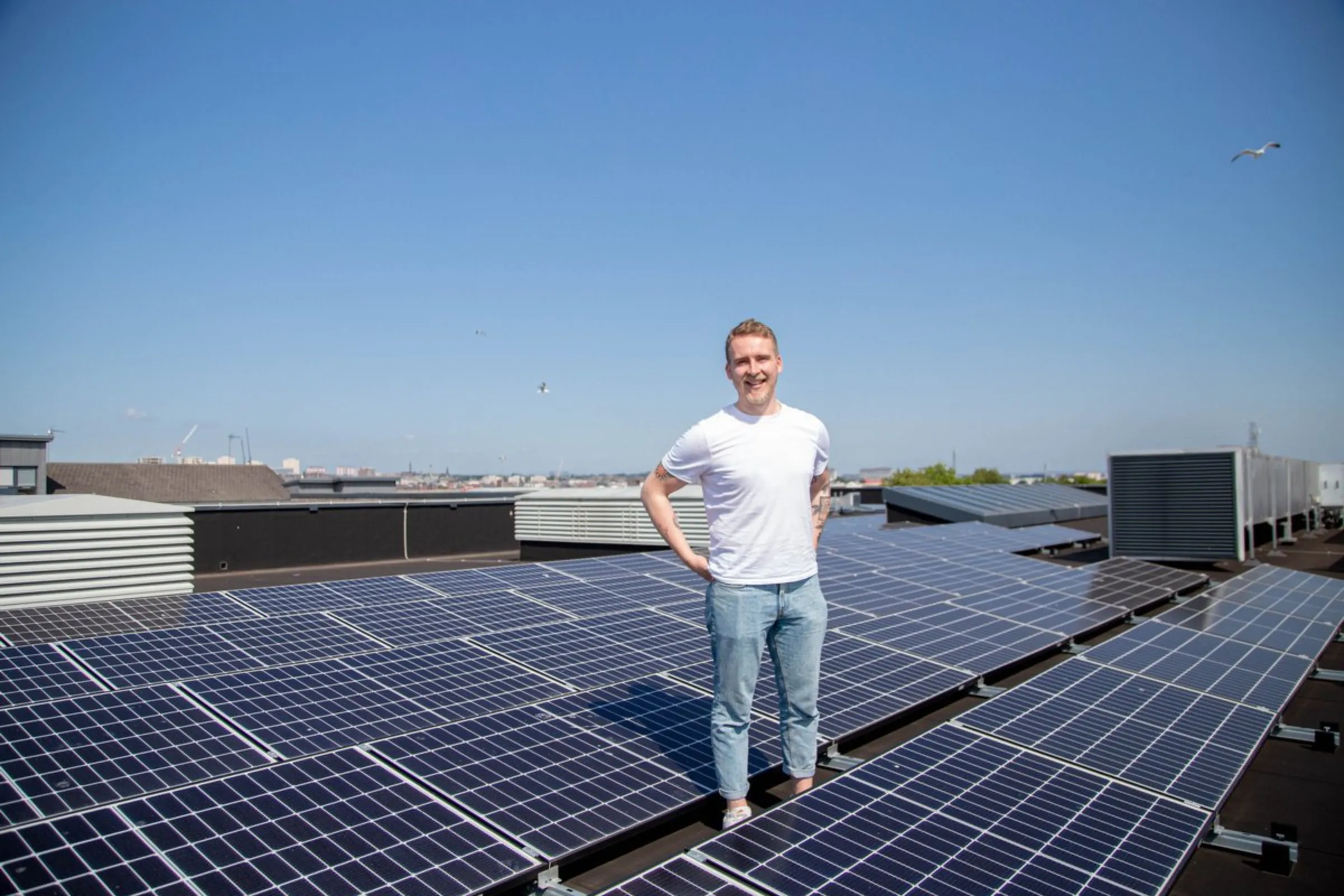 Glasgow Community Energy board member Fraser Stewart stands amid solar panels installed on top of the Glendale Primary School in Glasgow, United Kingdom, July 21, 2021