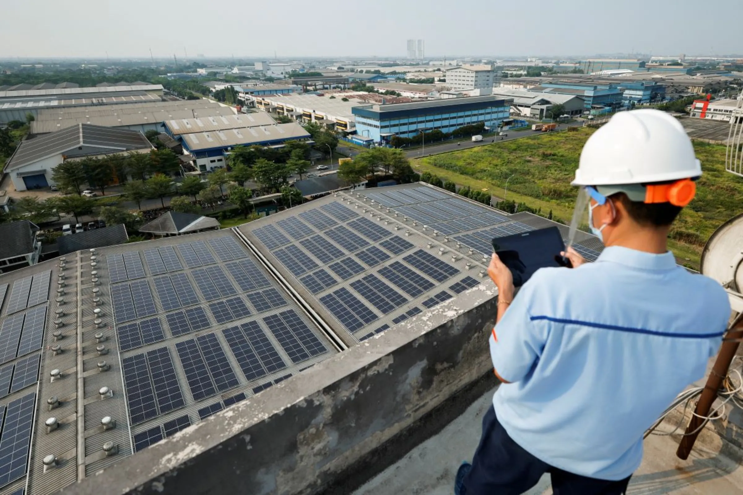 An engineer checks the electrical power from the solar panels that are installed on the roof of Bogasari Flour Mills factory in Bekasi, West Java province, Indonesia, September 15, 2022