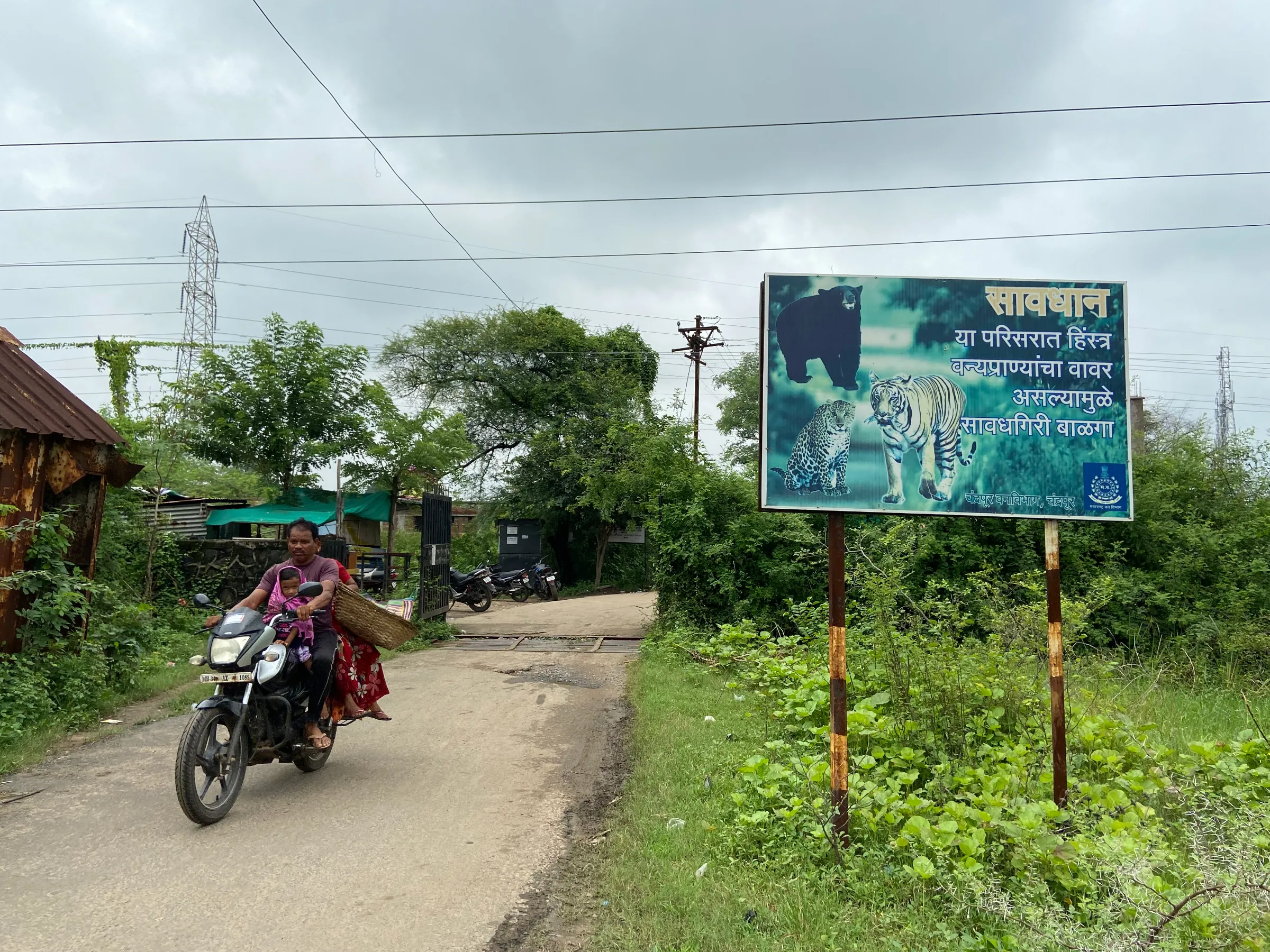 A signboard cautioning residents to stay alert to wildlife movement outside Khairgaon village in Chandrapur, India, August 19, 2021