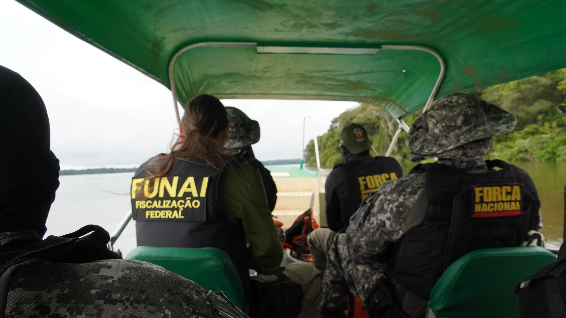 Agents from Indigenous affairs agency, FUNAI, and Brazil’s public security force travel by boat to the Munduruku Indigenous Reserve, Brazil, Jan 9, 2025. Thomson Reuters Foundation/Dan Collyns