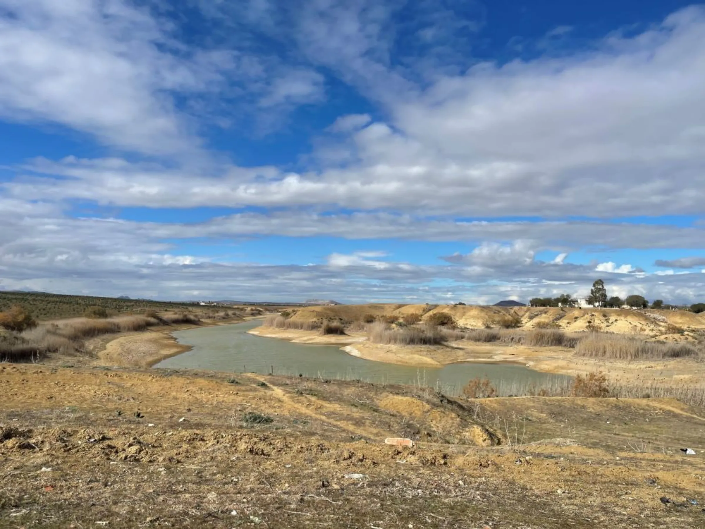 A water-depleted dam is seen near a farm northeastern Tunisia, January 30, 2023