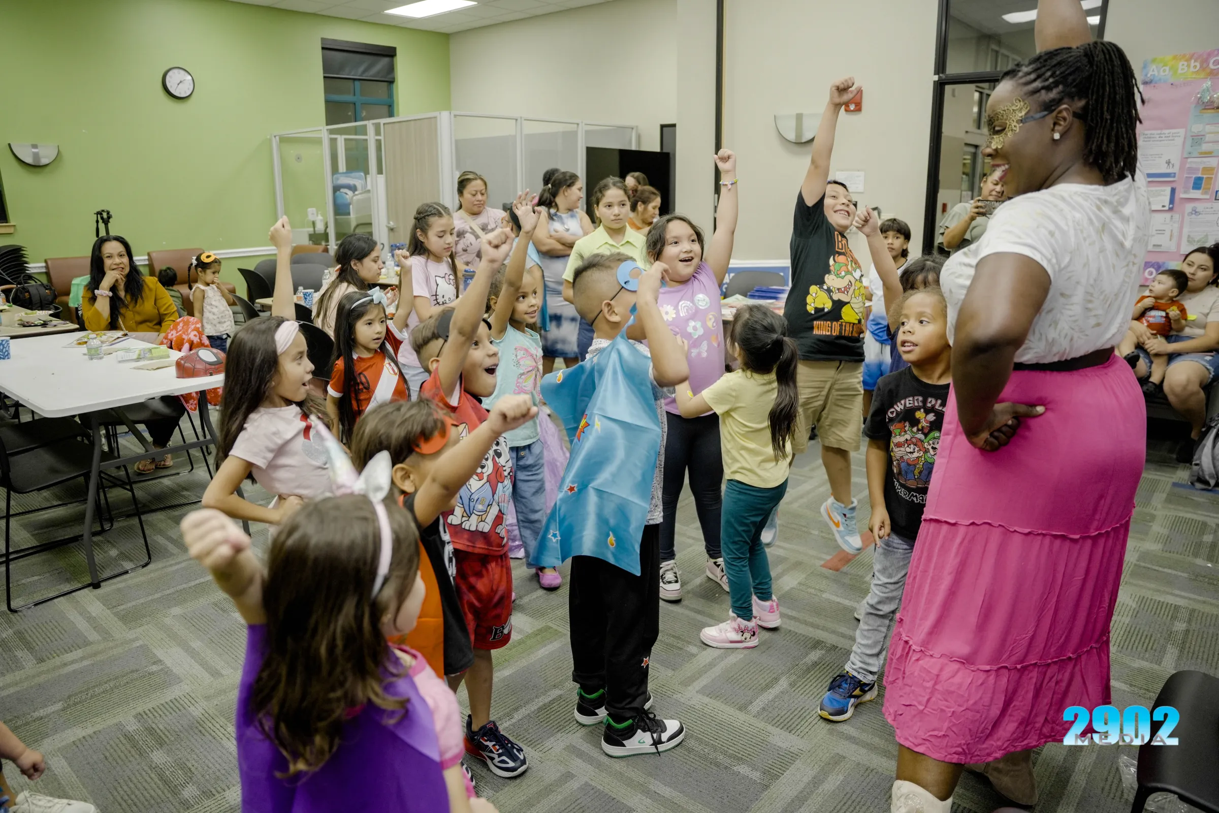 Childcare Changemakers advocate BriTanya Brown leads a group of children in Austin, Texas, during a national childcare voter day of action on October 31, 2024. 2902 Media/Handout via Thomson Reuters Foundation