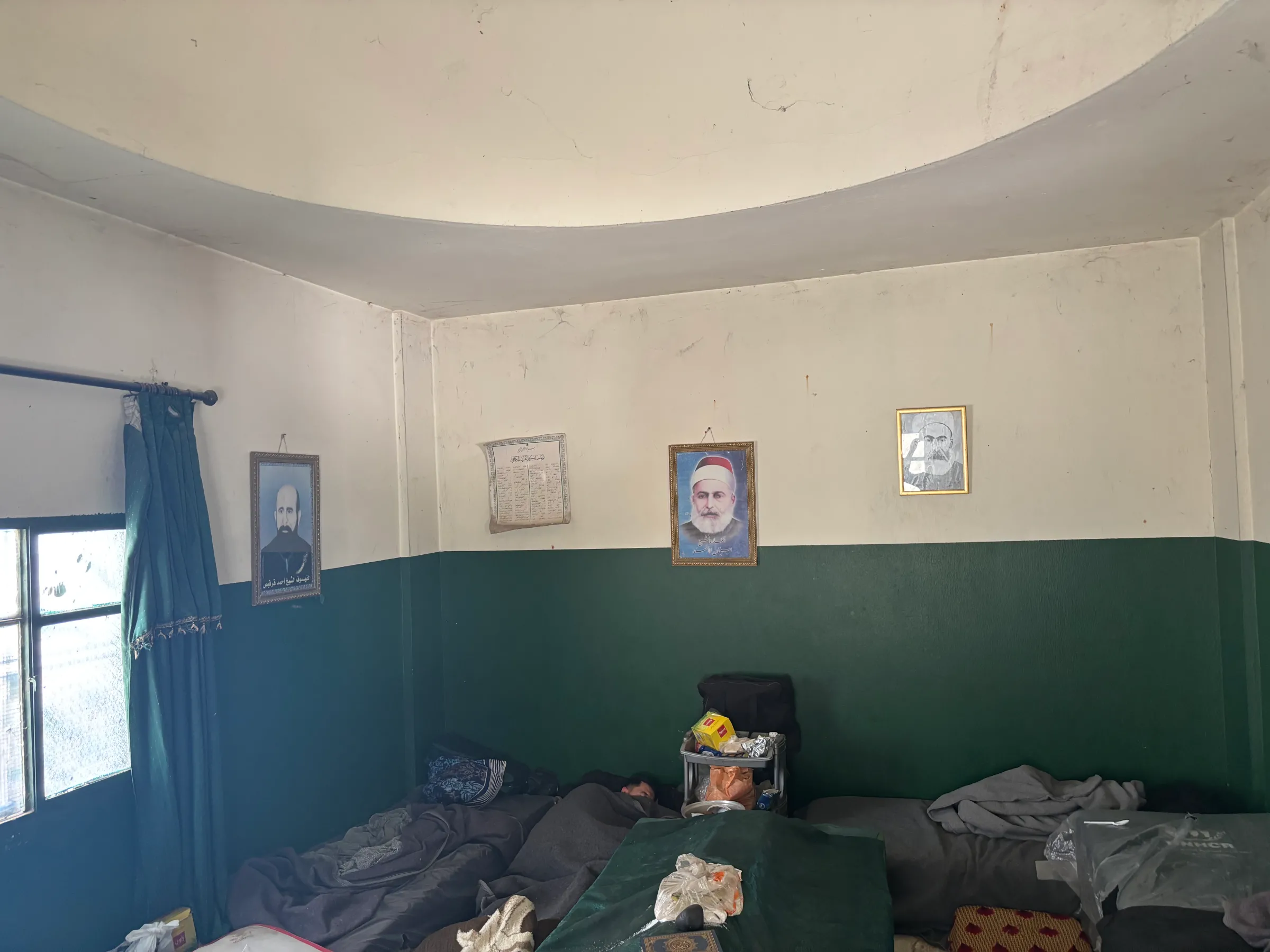 People sleep by the shrine of a saint at the mosque in Hissa, Lebanon. May 9, 2025. Thomson Reuters Foundation/Nazih Osseiran