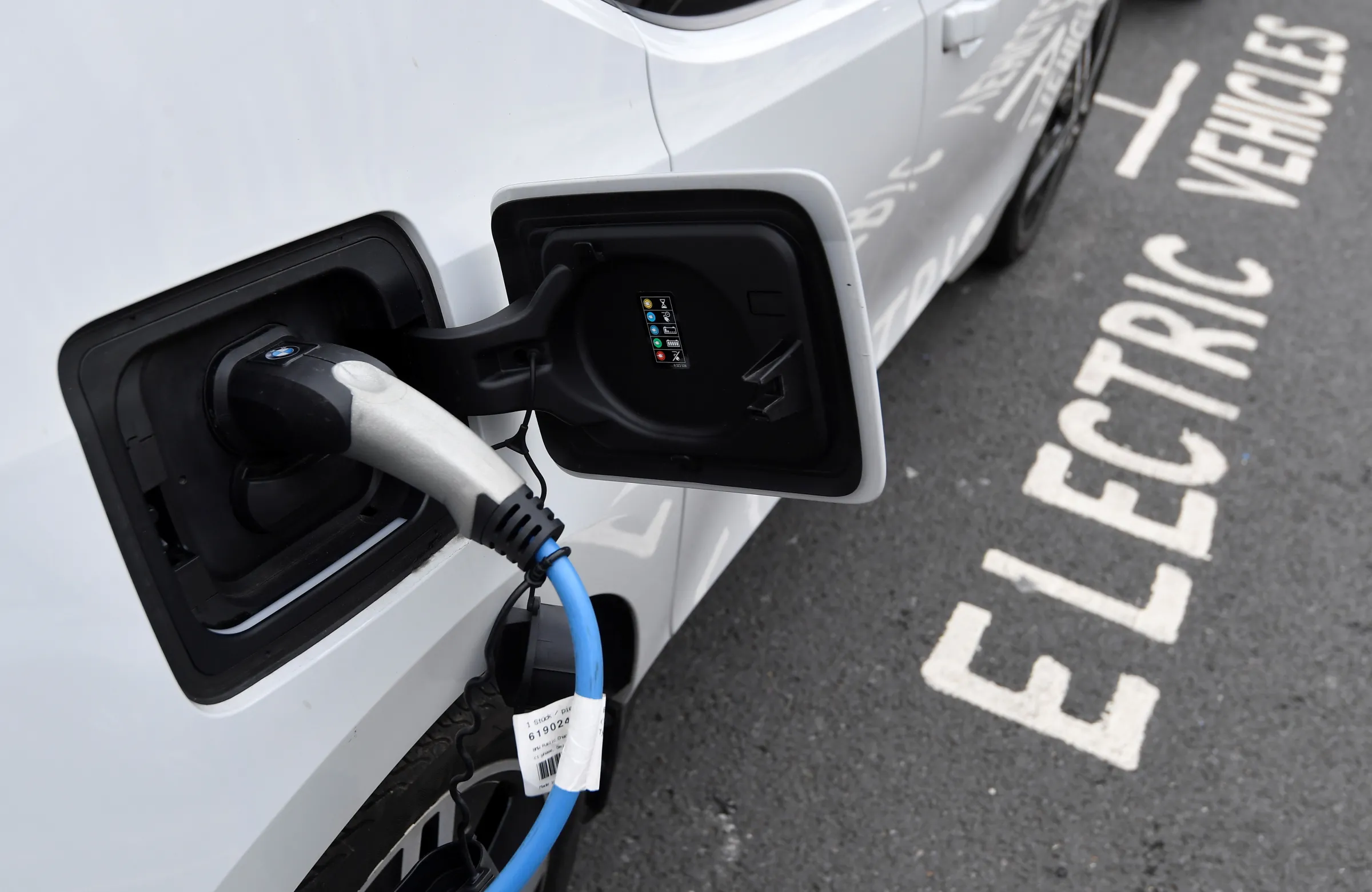 An electric car is charged at a roadside EV charge point, London, October 19, 2021