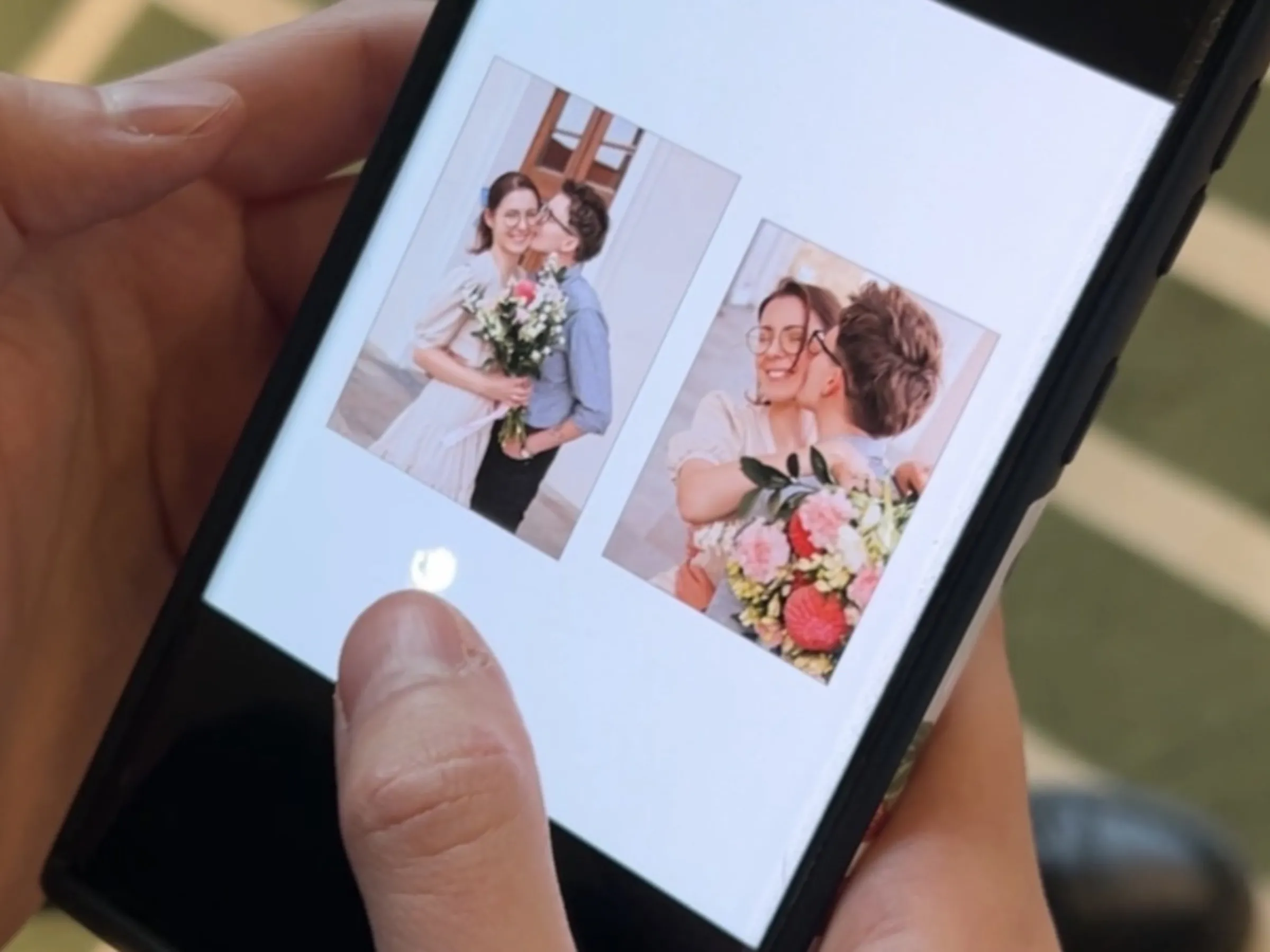 Eglė scrolls through photos of her and Karolina's same-sex civil partnership ceremony in September, while at the Radisson Blu Hotel in Vilnius, Lithuania, on October 23. Lucy Middleton/Thomson Reuters Foundation