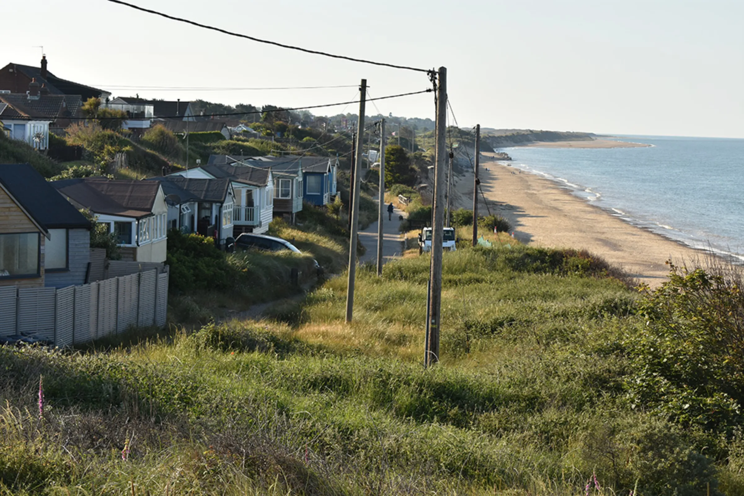 Houses along the partially collapsed coastal road known as The Marrams in Hemsby, England, June 15, 2023. Thomson Reuters Foundation/Rachel Parsons