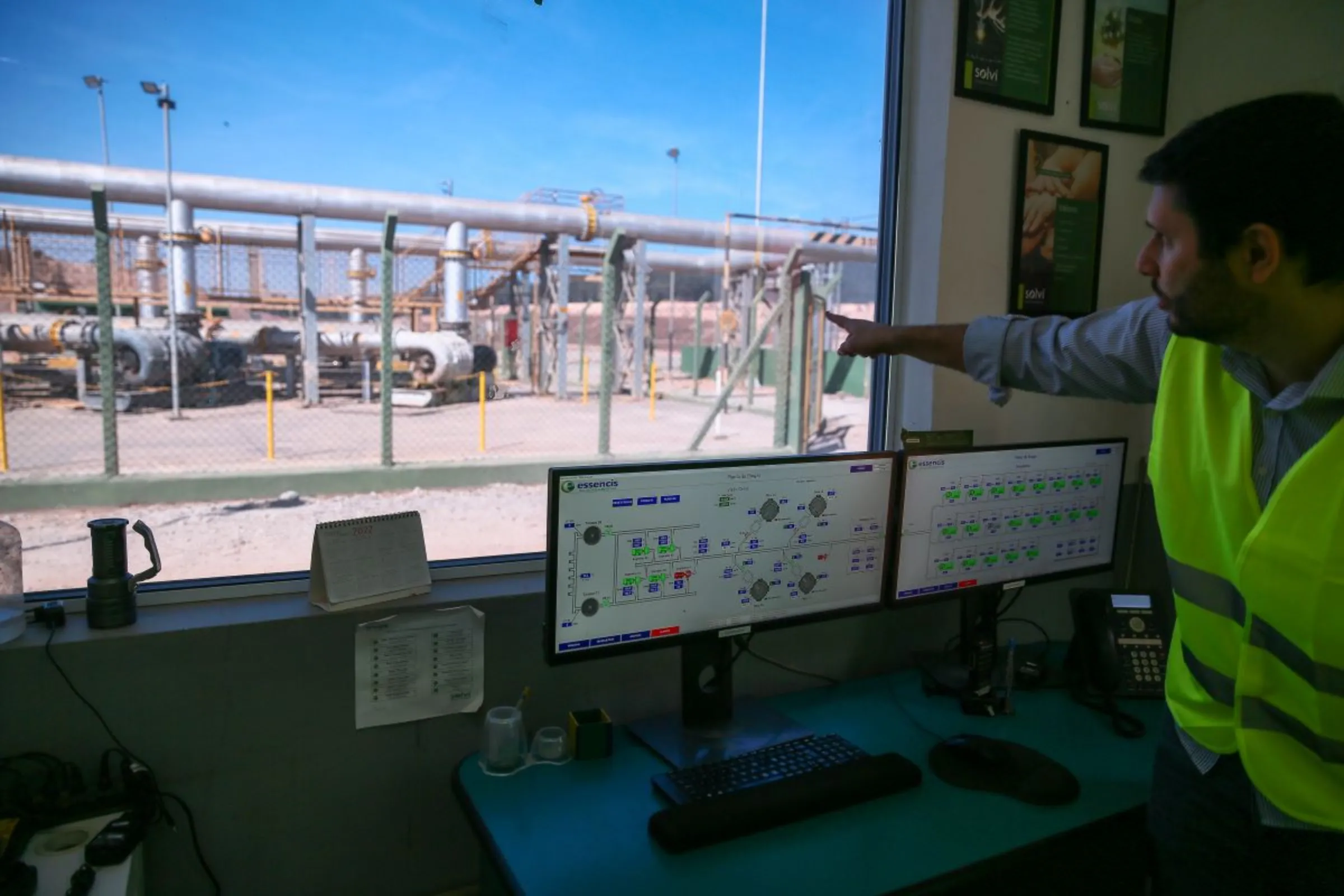 Diego Nicoletti, technical director for Solvi, points to a landfill in Caieiras, Brazil, July 22, 2022