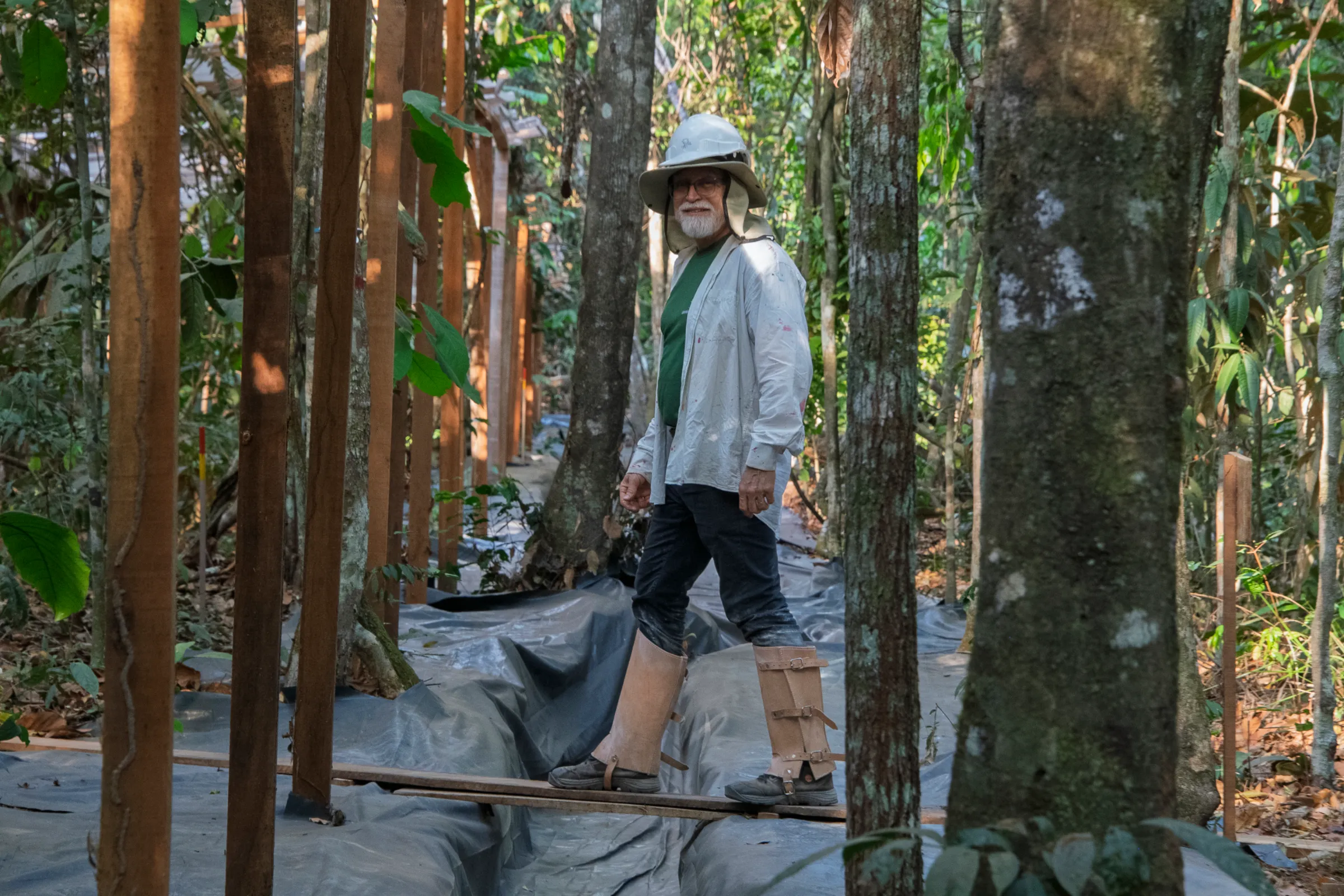 Researcher Ben Hur Marimon Jr. walks over a plastic-covered gutter on a patch of Amazon forest in the Limit Drought experiment, in Querência, Brazil, August 25, 2025. Thomson Reuters Foundation/Rogério Florentino