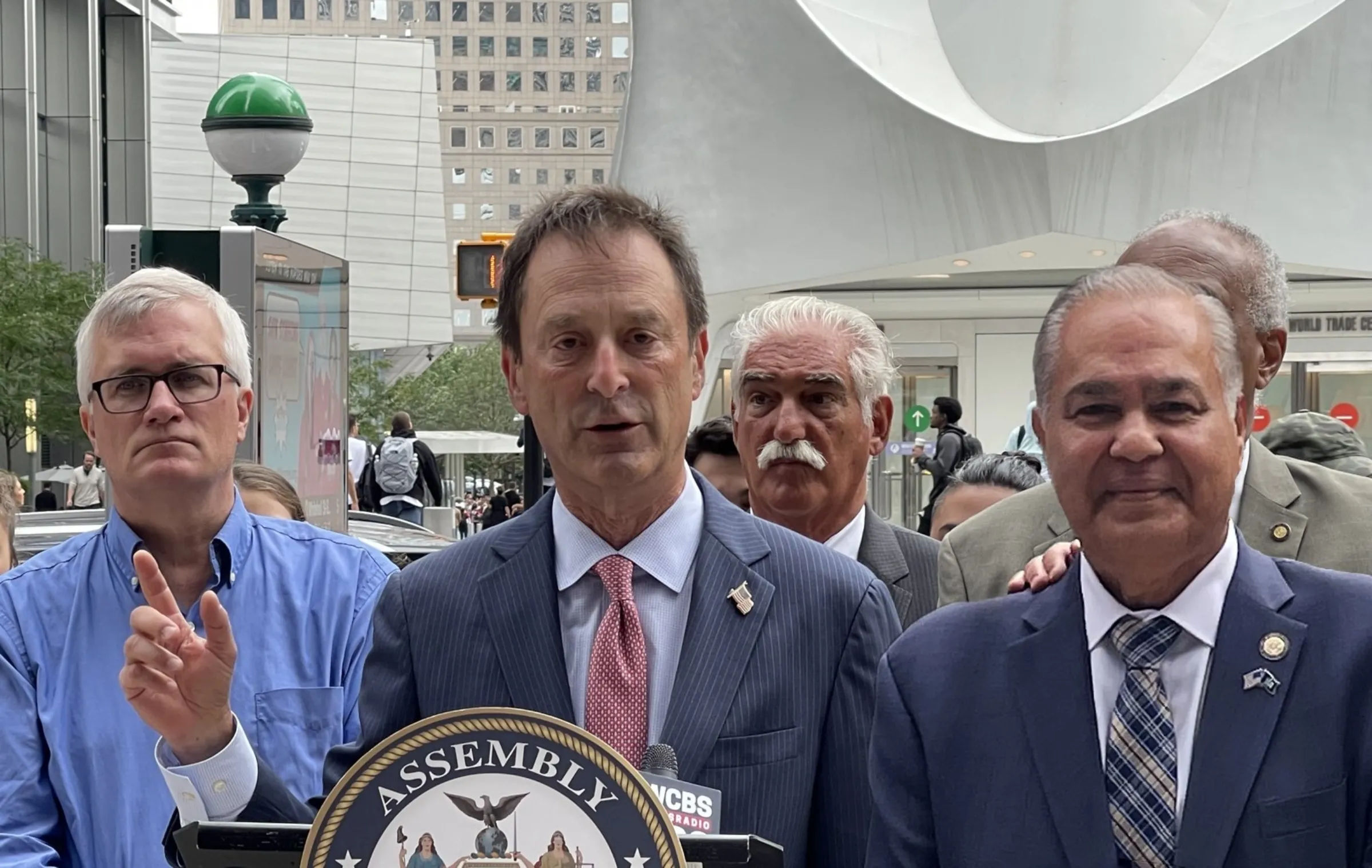 Attorney Michael Barasch, center, speaks alongside New York state legislators in September 2022. Michael Barasch & McGarry/Handout via Thomson Reuters Foundation