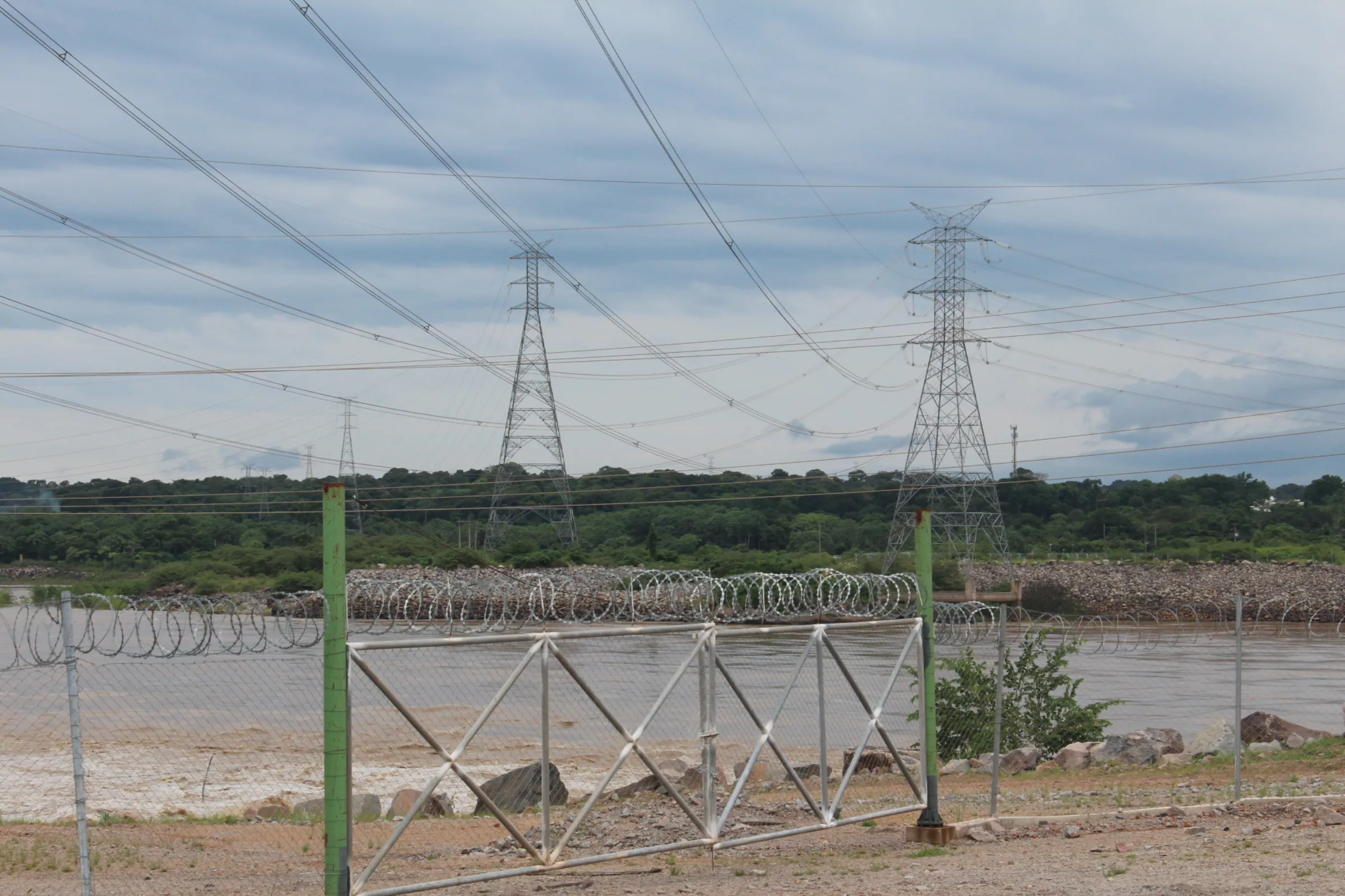 Transmission towers from the Santo Antônio hydropower dam in the Madeira river in Porto Velho, Brazil’s Amazon, Feb. 24, 2024. Thomson Reuters Foundation/André Cabette Fábio