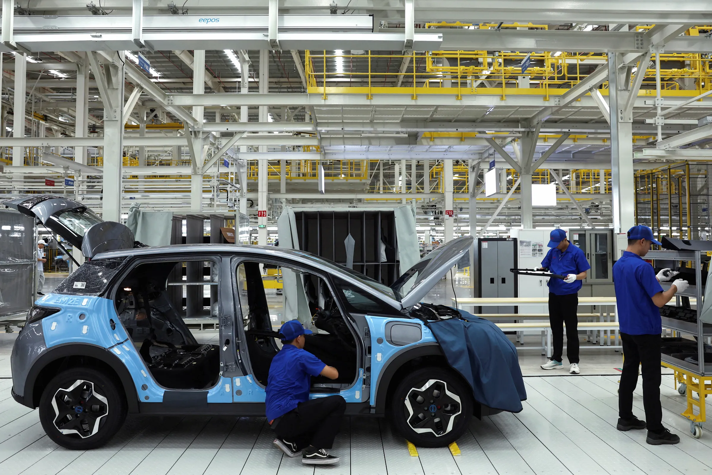 Workers assemble an EV car inside BYD's first electric vehicle (EV) factory in Southeast Asia, a fast-growing regional EV market where it has become the dominant player, in Rayong, Thailand, July 4, 2024. REUTERS/Chalinee Thirasupa